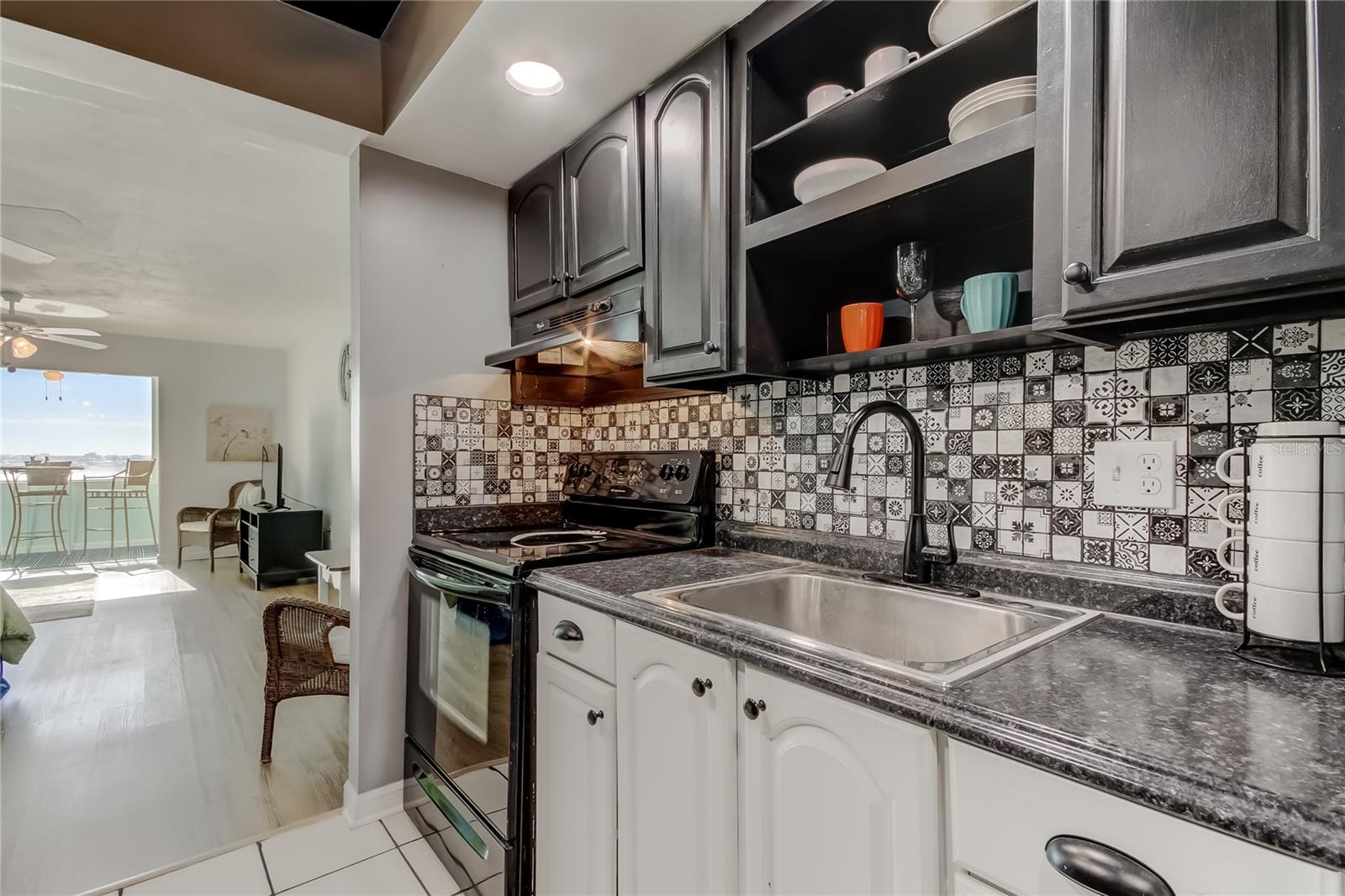 The galley style kitchen is modern and bright