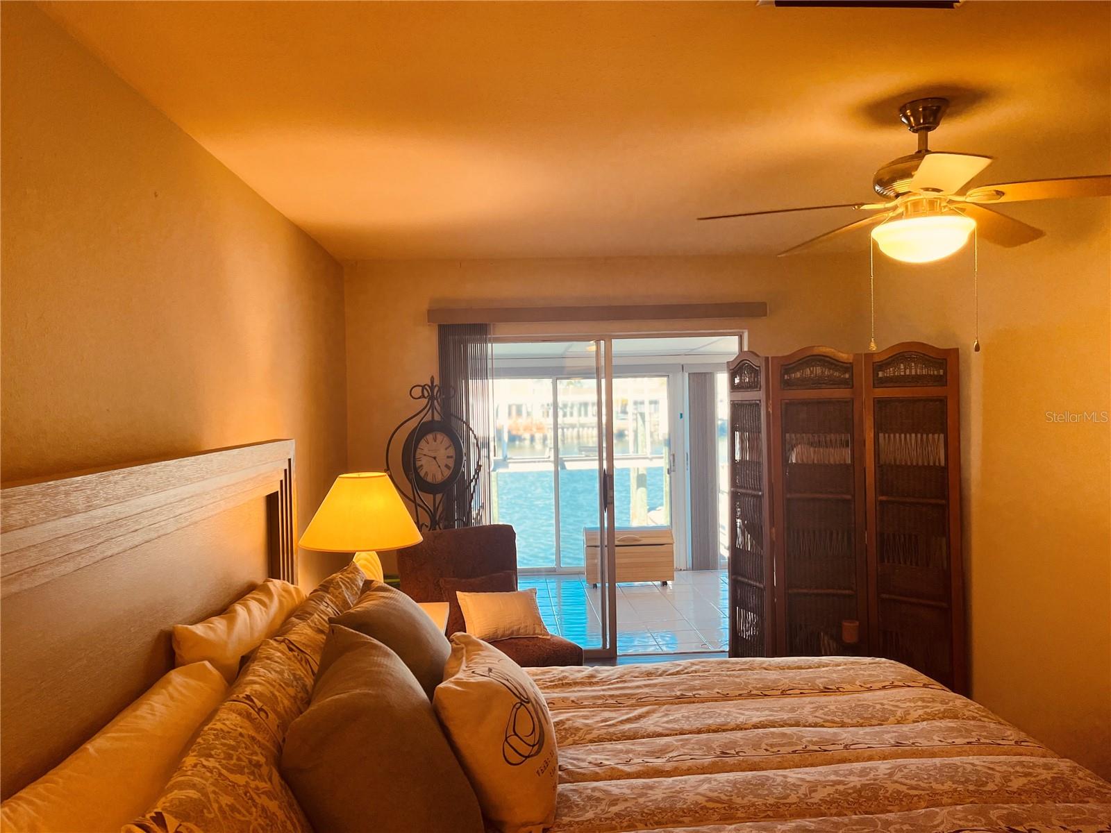 The view looking from your king-size bed out through both sets of slide sliders to the waterfront!