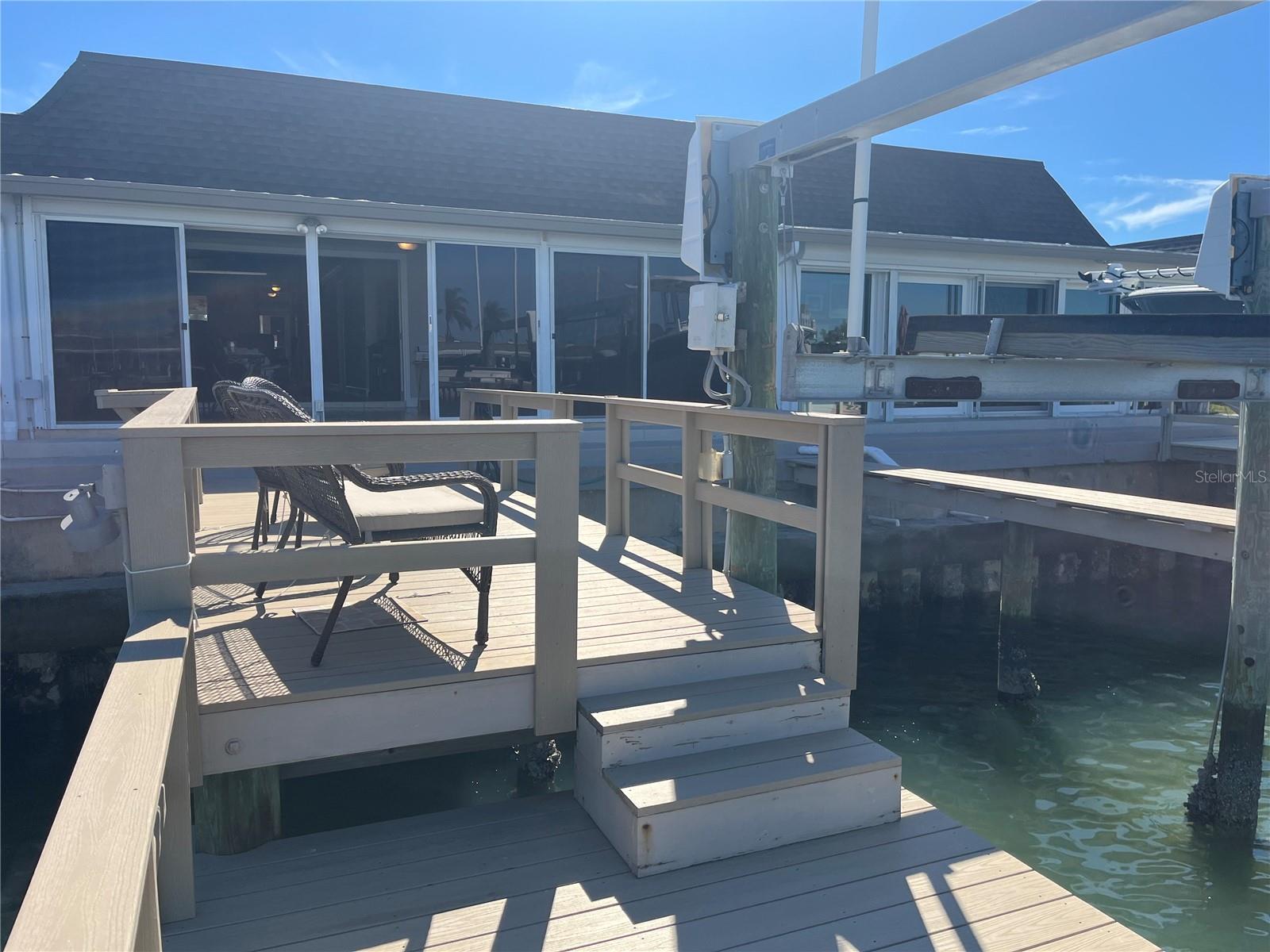 Your view standing on the lower tier of your composite boat dock, looking back into your waterfront villa/condo!