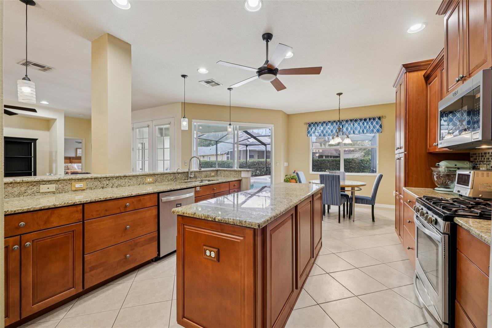 Beautiful kitchen with 42 inch cabinets, wood pantry, granite, backsplash and stainless steel appliances (oven is gas)