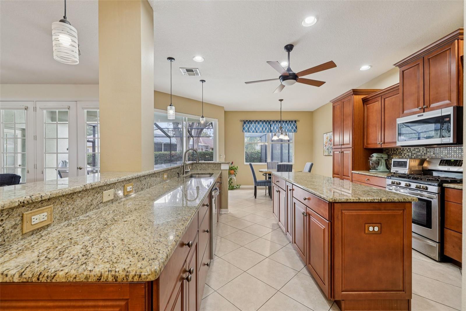 Beautiful kitchen with 42 inch cabinets, wood pantry, granite, backsplash and stainless steel appliances (oven is gas)
