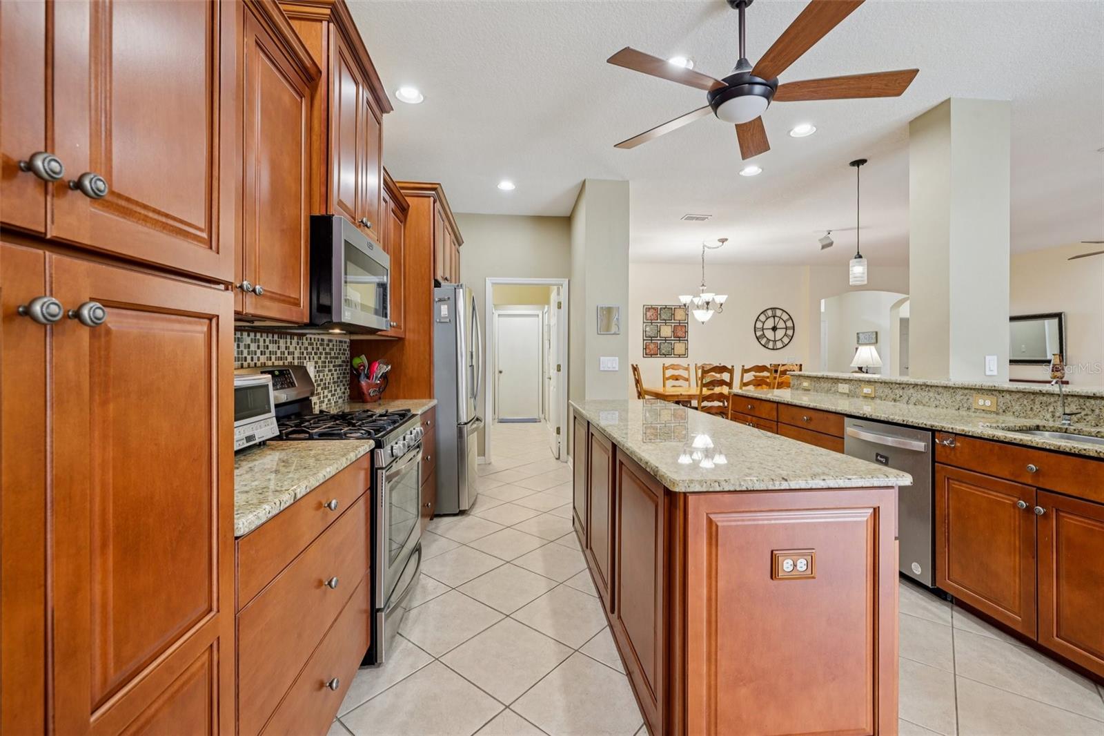 Beautiful kitchen with 42 inch cabinets, wood pantry, granite, backsplash and stainless steel appliances (oven is gas)