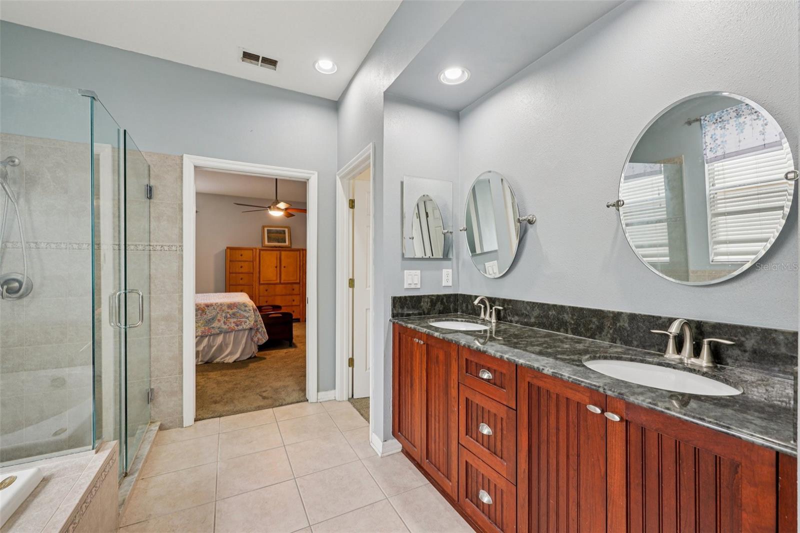 Primary bathroom with large walk in shower and jacuzzi tub and dual vanity