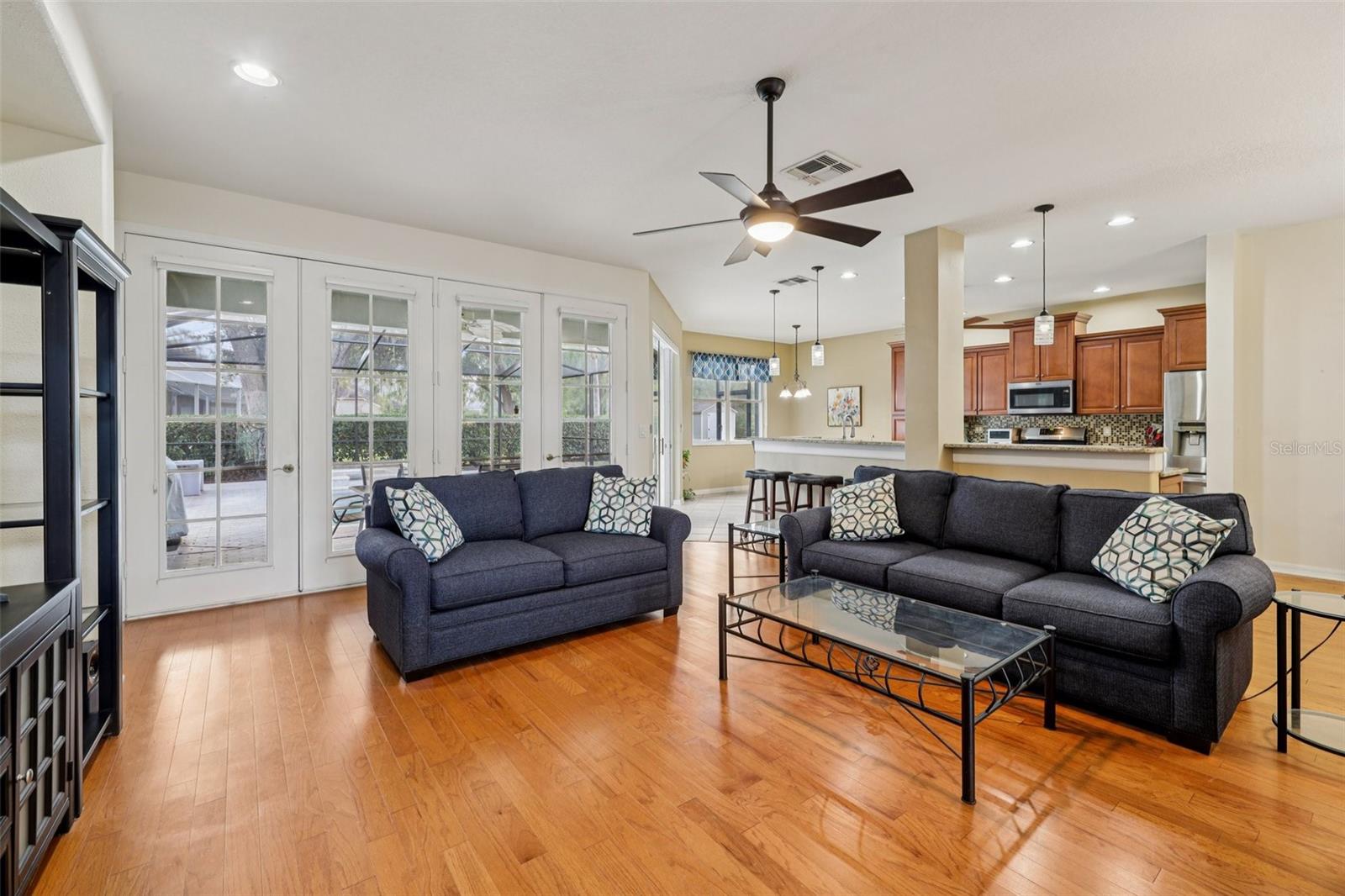 Living Room with view to outside Lanai, Kitchen and Dining Areas