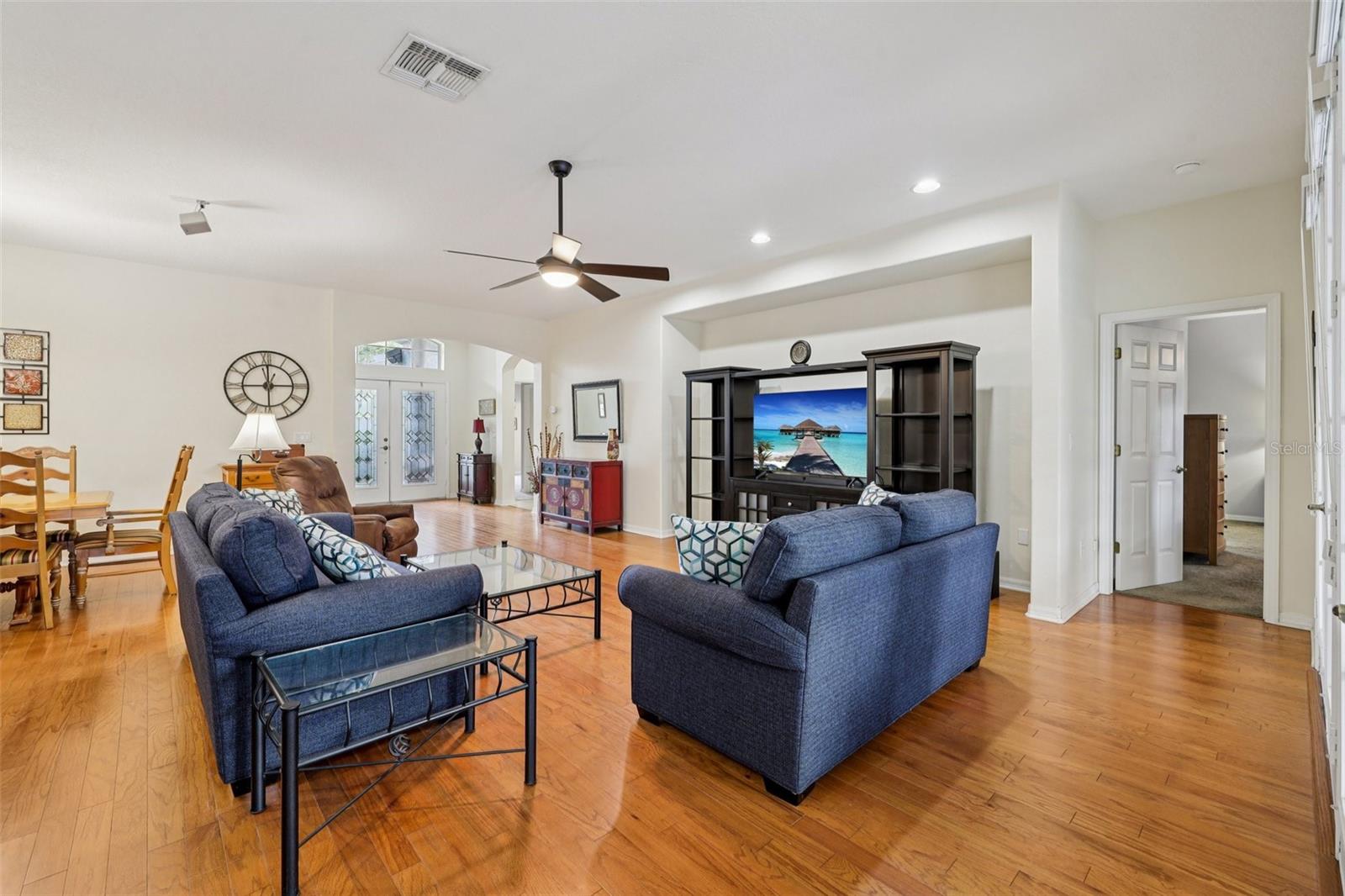 Living Room with view to outside Lanai, Kitchen and Dining Areas