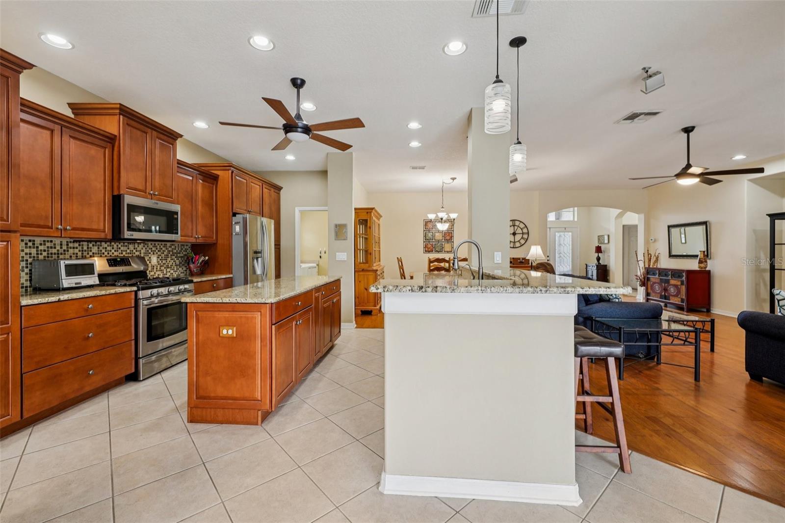 Beautiful kitchen with 42 inch cabinets, wood pantry, granite, backsplash and stainless steel appliances (oven is gas)