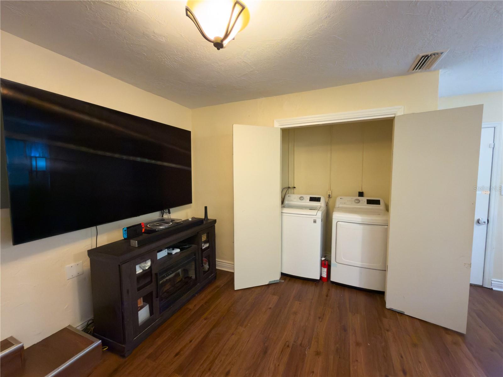 Living room with laundry area doors open