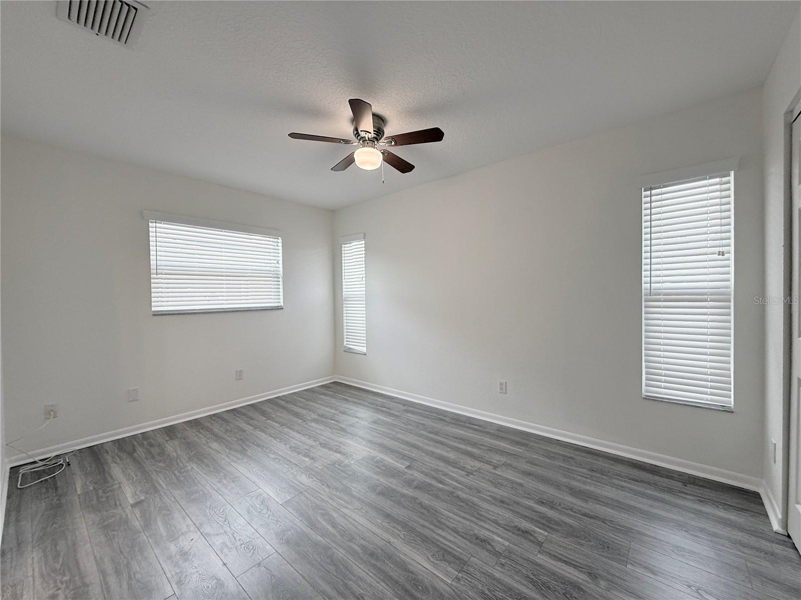 Master bedroom with ample natural light and plantation blinds