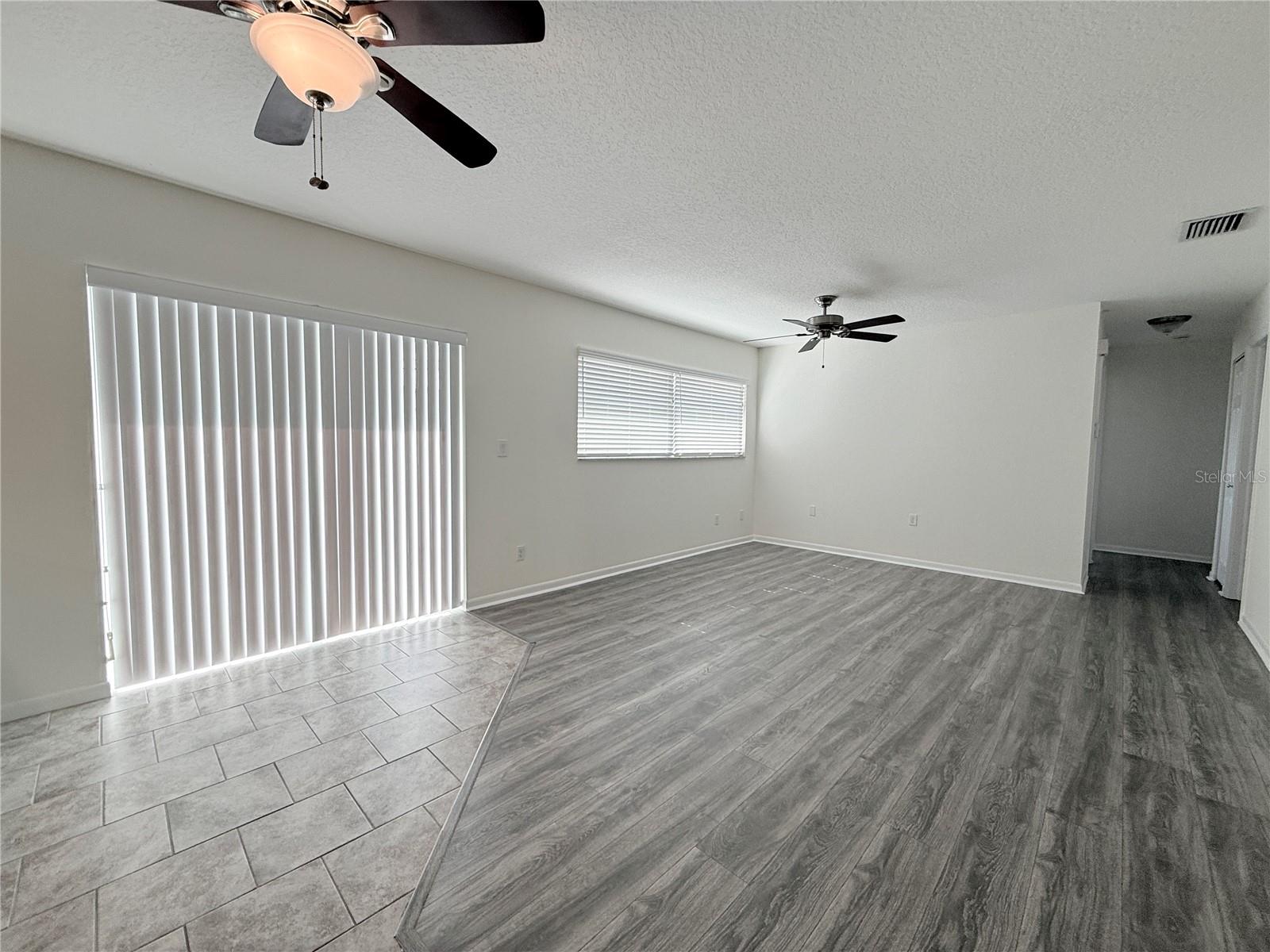 Vertical blinds on sliding glass door and plantation shutters on windows in family room and all bedrooms