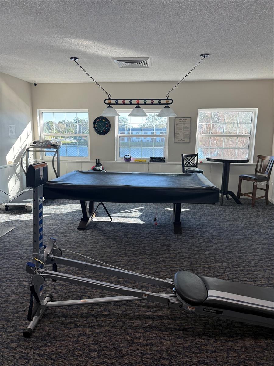 Exercise room with pool table