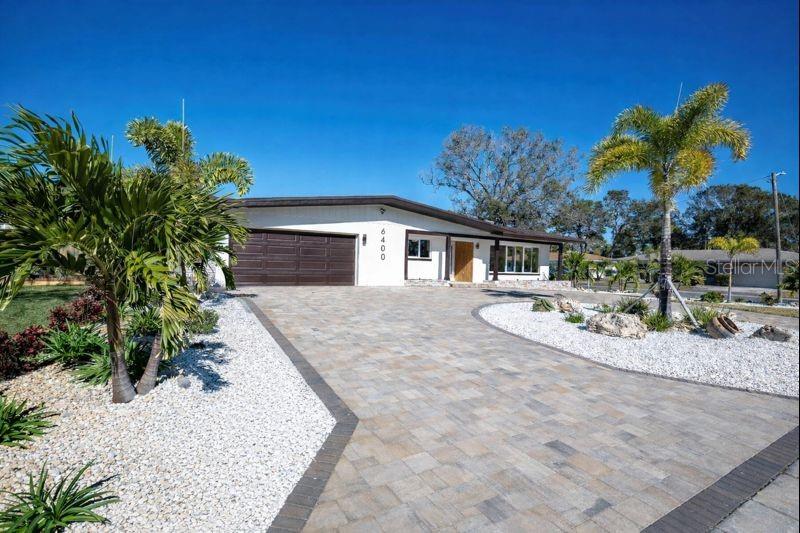 Arrive in style on the newly installed paver driveway.  This home is genuinely striking!