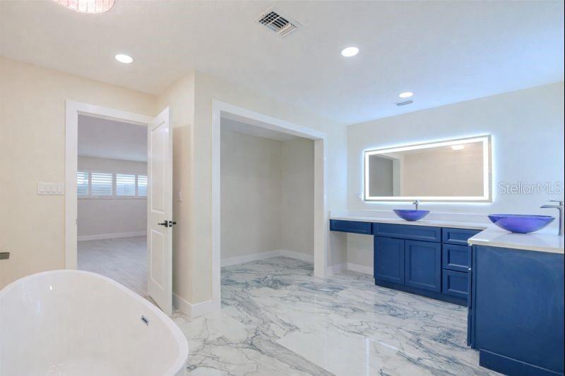 The primary ensuite provides generous space & showcases elegant, thoughtfully curated designer touches.