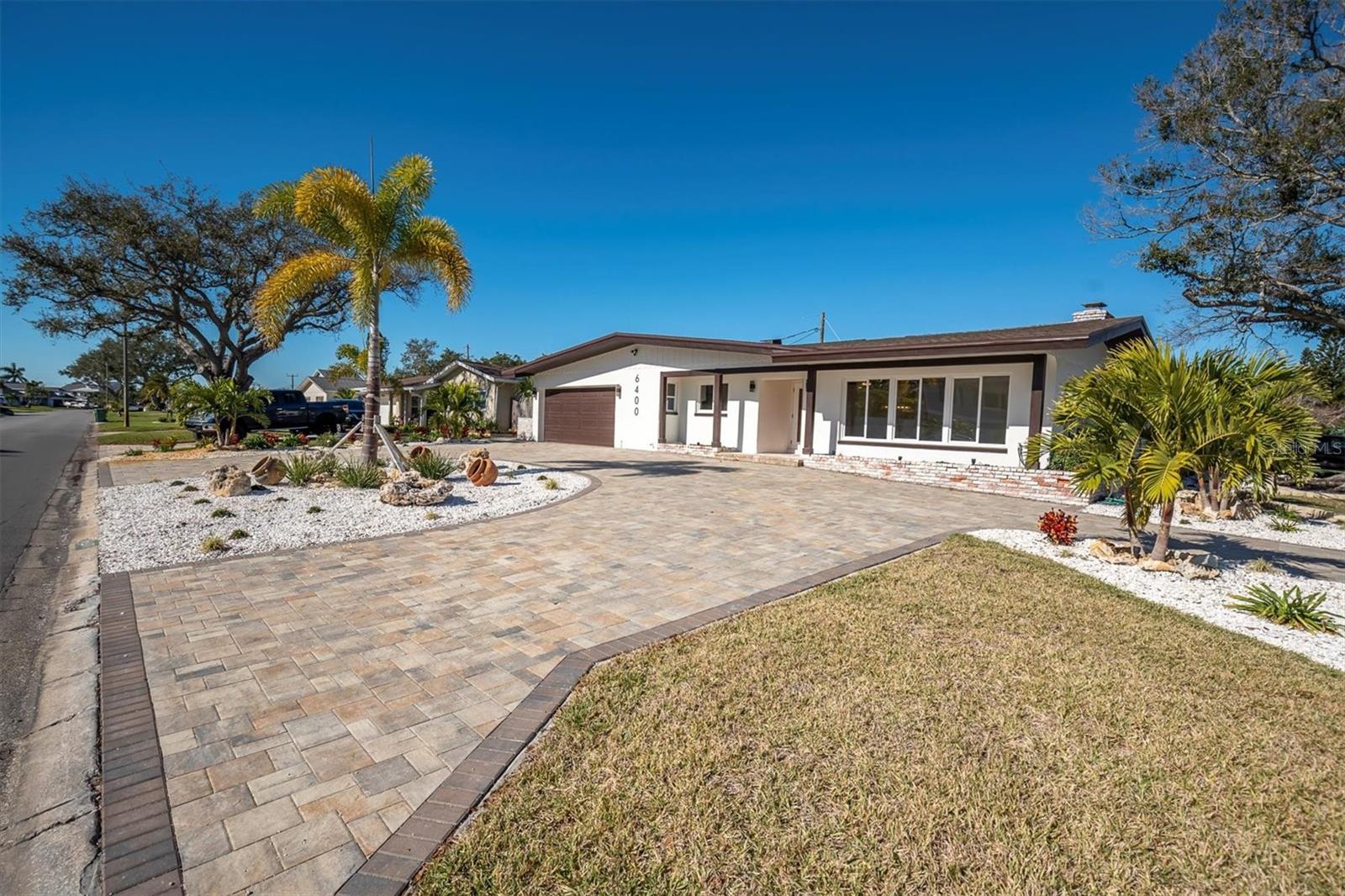 The paved circular driveway enhances the home with timeless elegance while providing added convenience & ample guest parking.