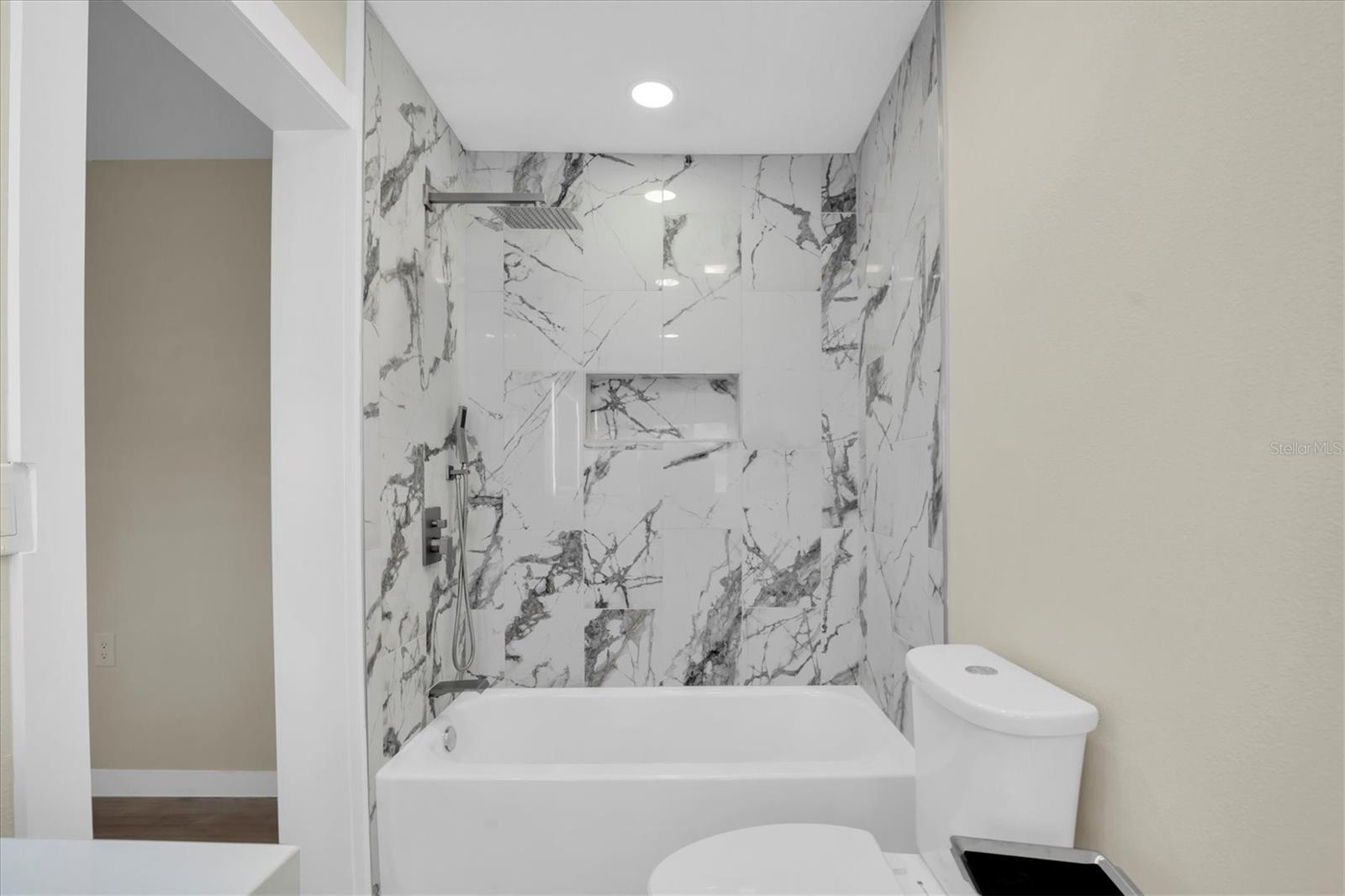 Exquisite tile frames both the tub & shower, while a refined built in niche provides a convenient & stylish place for your shampoos and soaps.