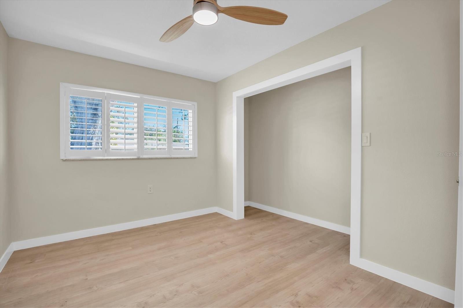 The 4th bedroom showcases elegant plantation shutters.   The owner is in the process of installing new closet doors.