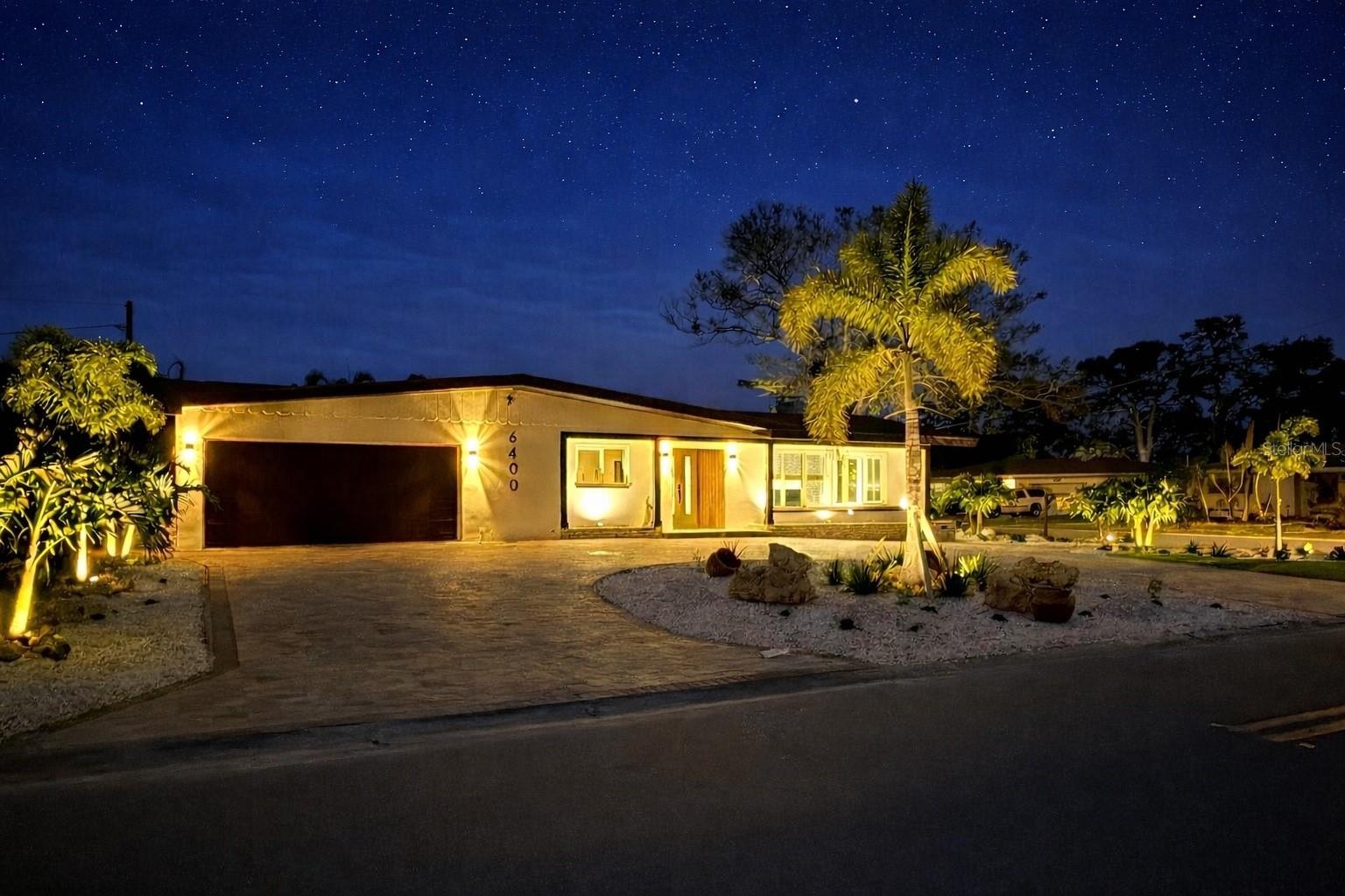 With both security & ambient evening lighting, the home is beautifully showcased after sunset, highlighting its refined architectural presence.