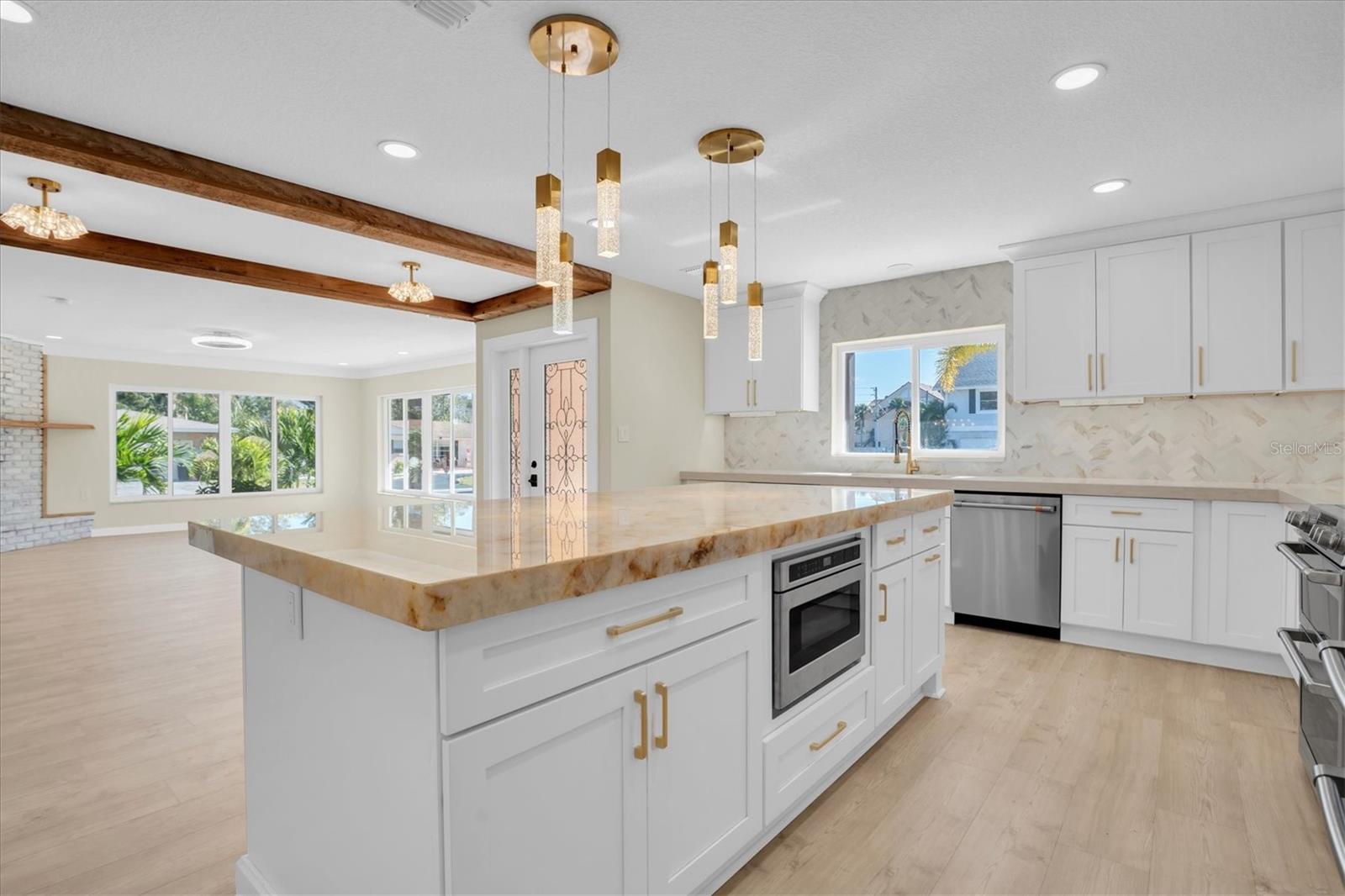 The kitchen is truly grand in design, offering a dream cooking space enhanced by premium, high end appliances.