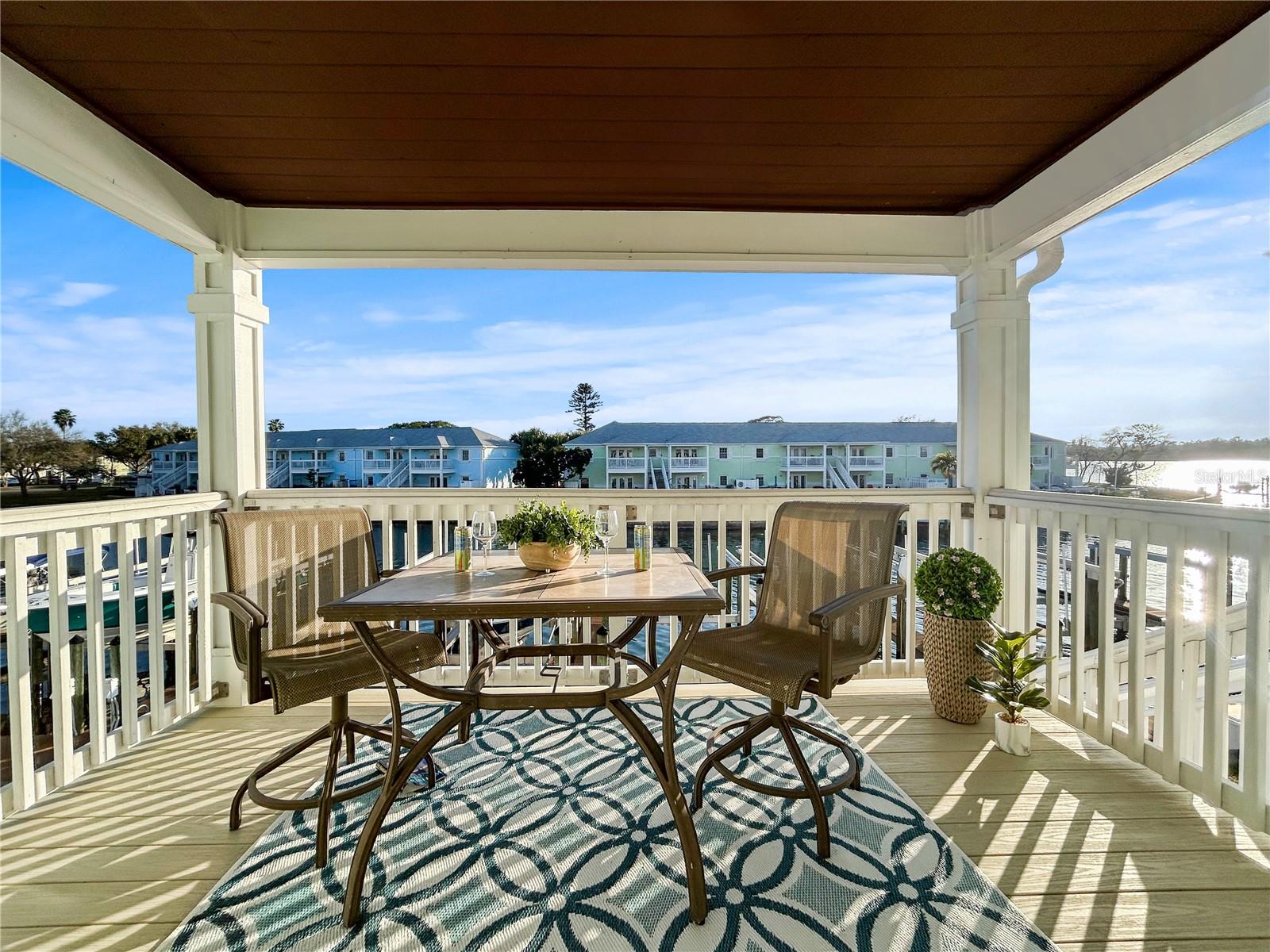 Balcony view overlooking waterway, docks and sunset bay views to west