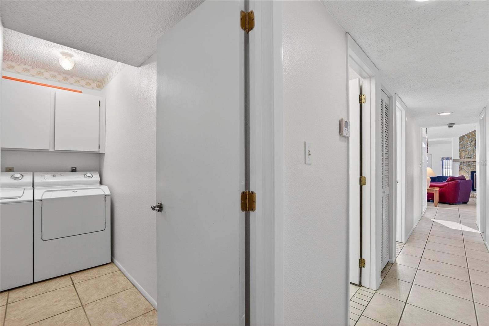 Hall view and laundry room.  Door to garage to the left.