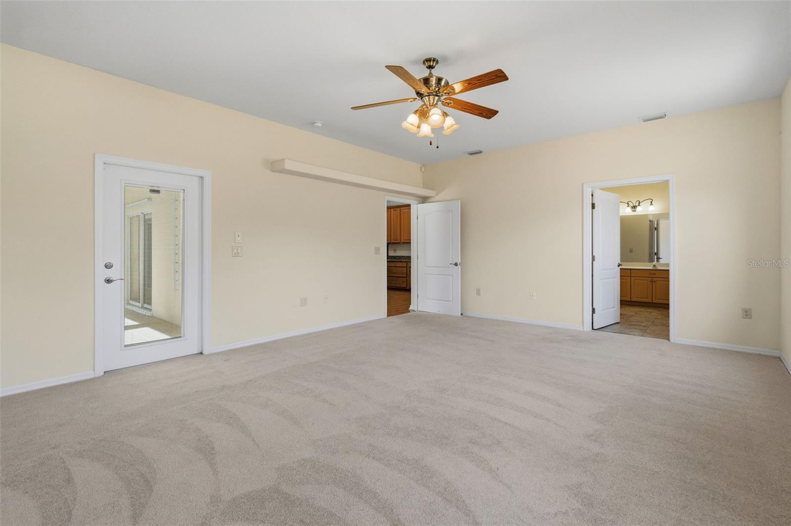 Another view of the Master with 3 extra wide doors: the entry, the Bath, Entrance to the Pool & Patio.