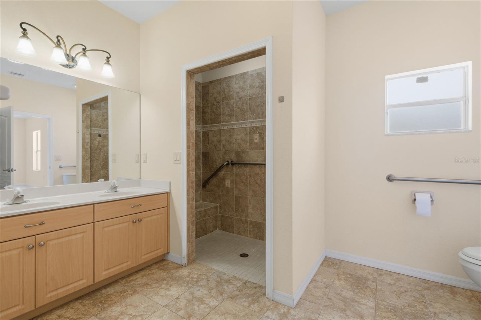 Master Bath with Roll-in Shower + Safety bars.