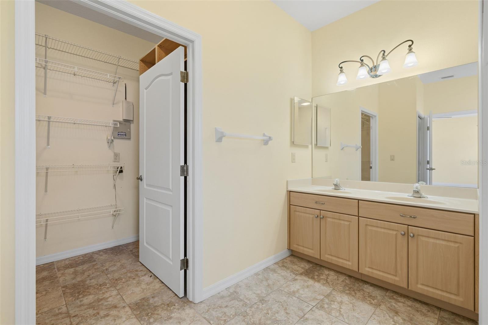 Double sinks and entry to the Walk-in Closet.