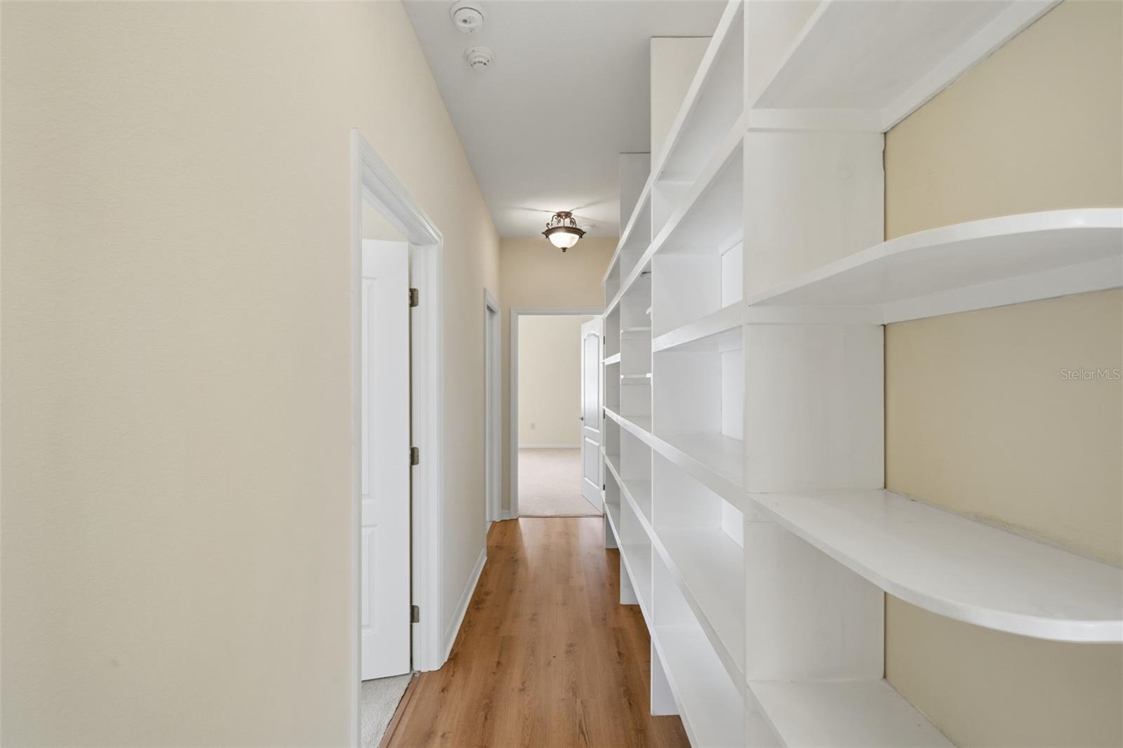 The Extra Wide Hallway in the Secondary Bedroom Wing with a built-in Bookcase for books or collectibles.