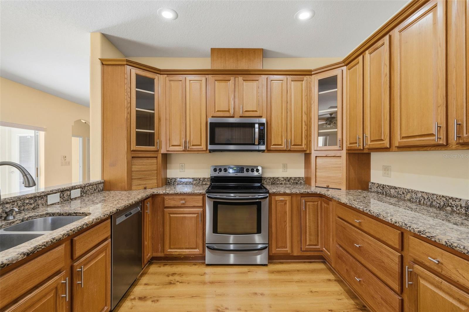 A U-Shaped Kitchen with granite counters, 2 appliance garages, SS appliances.