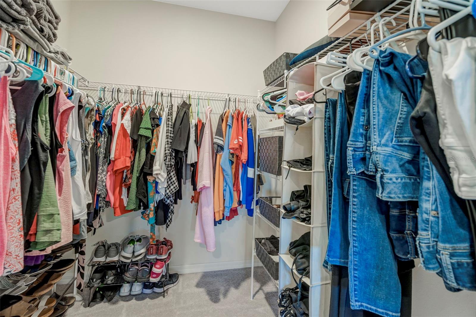 1 of 2 primary bedroom walk in closets