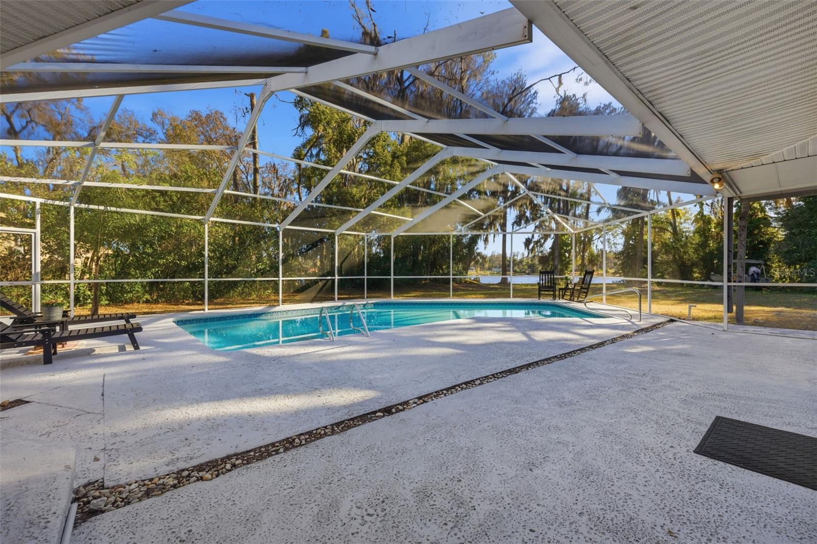 View of pool and lake from sliding doors