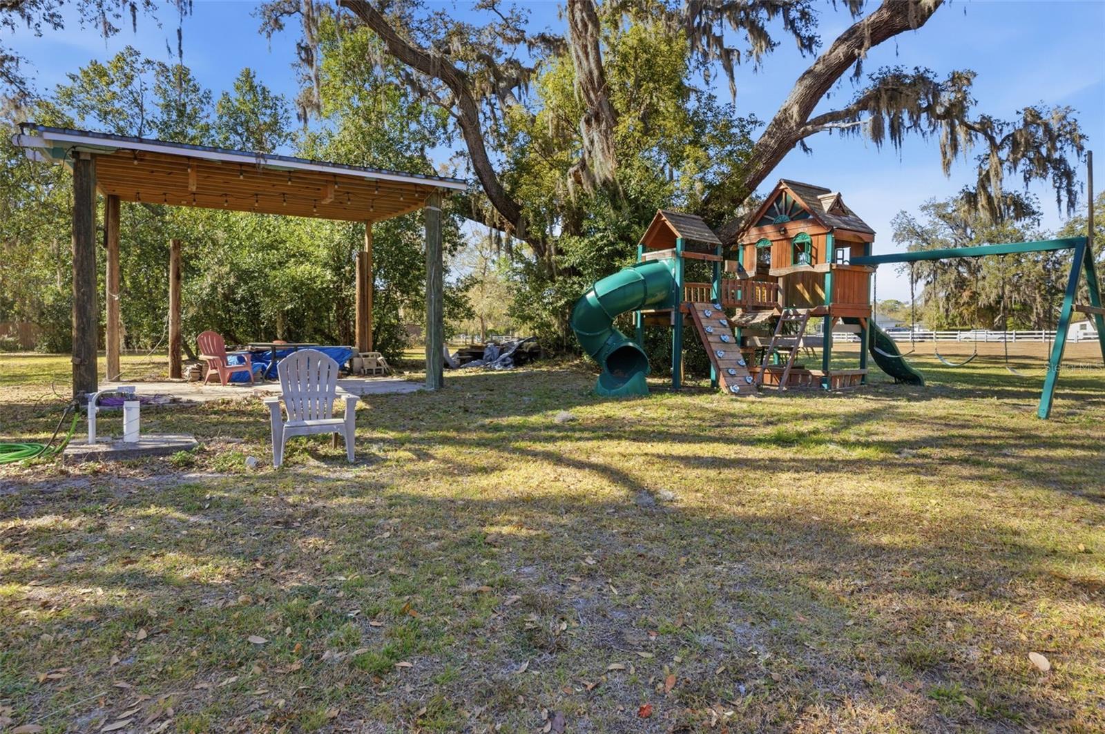 View of pole barn and play ground from driveway