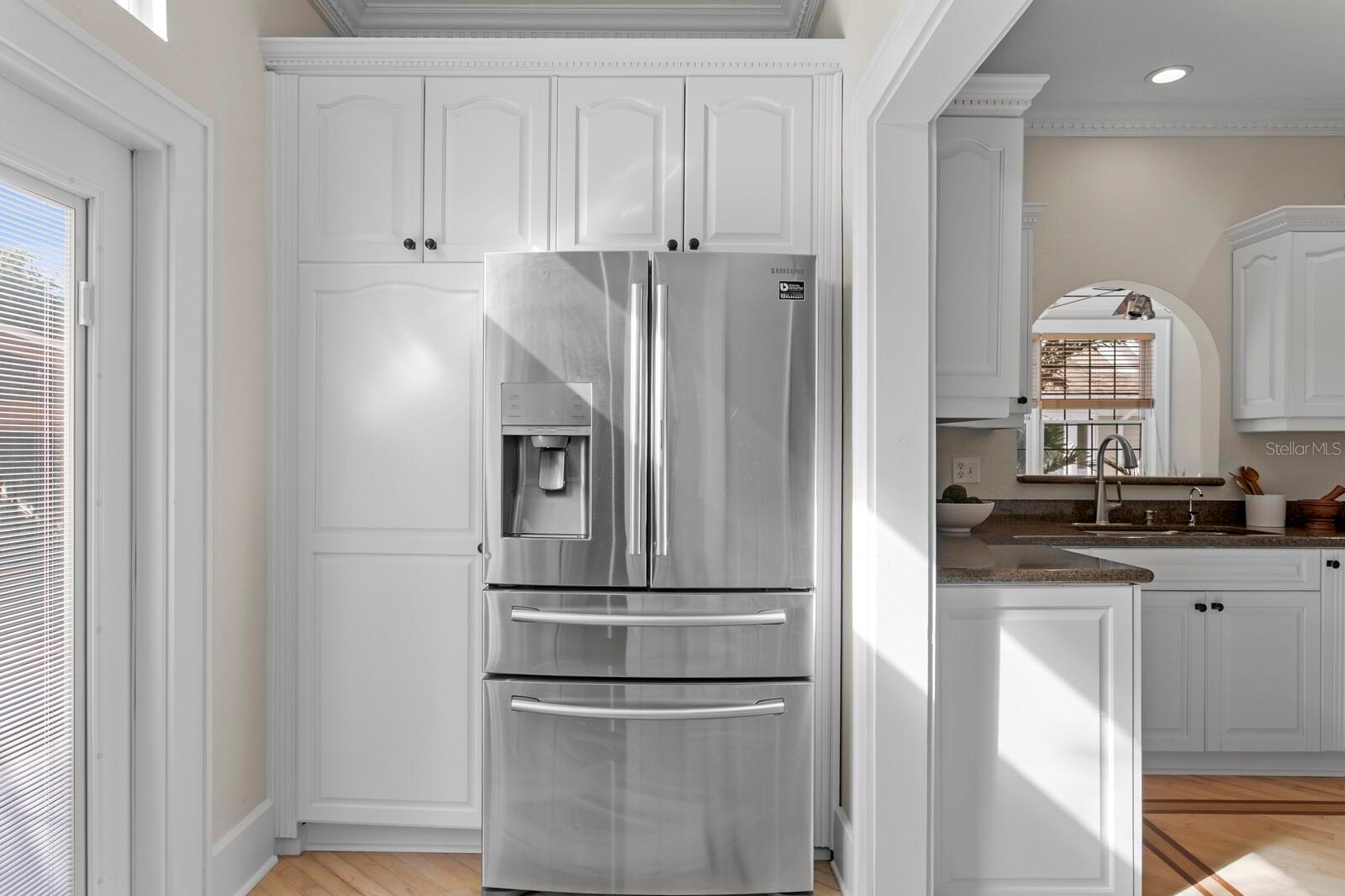 Kitchen connecting to backyard through double French doors