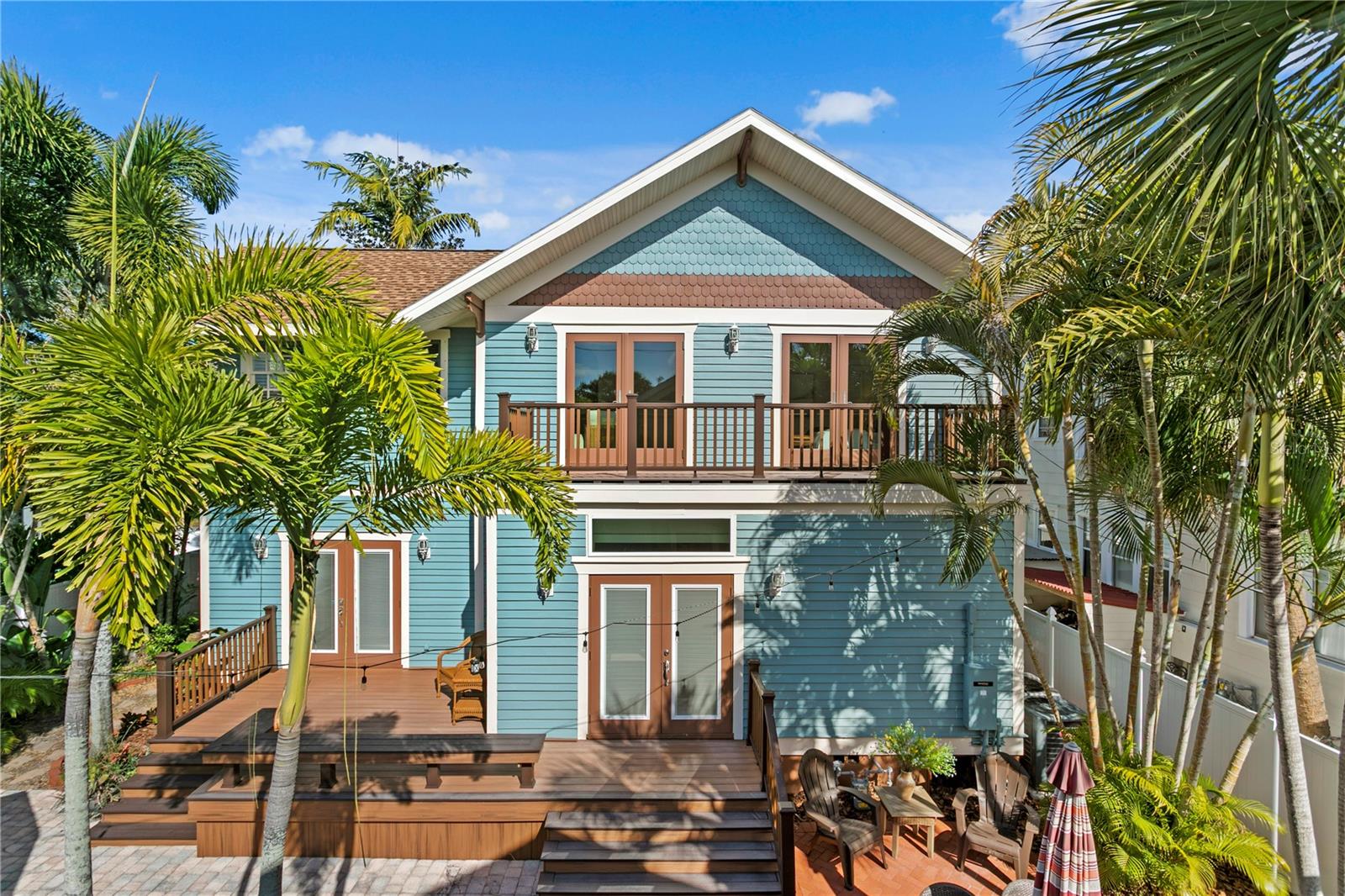 Property from the backyard with expansive private deck outside the Primary suite.