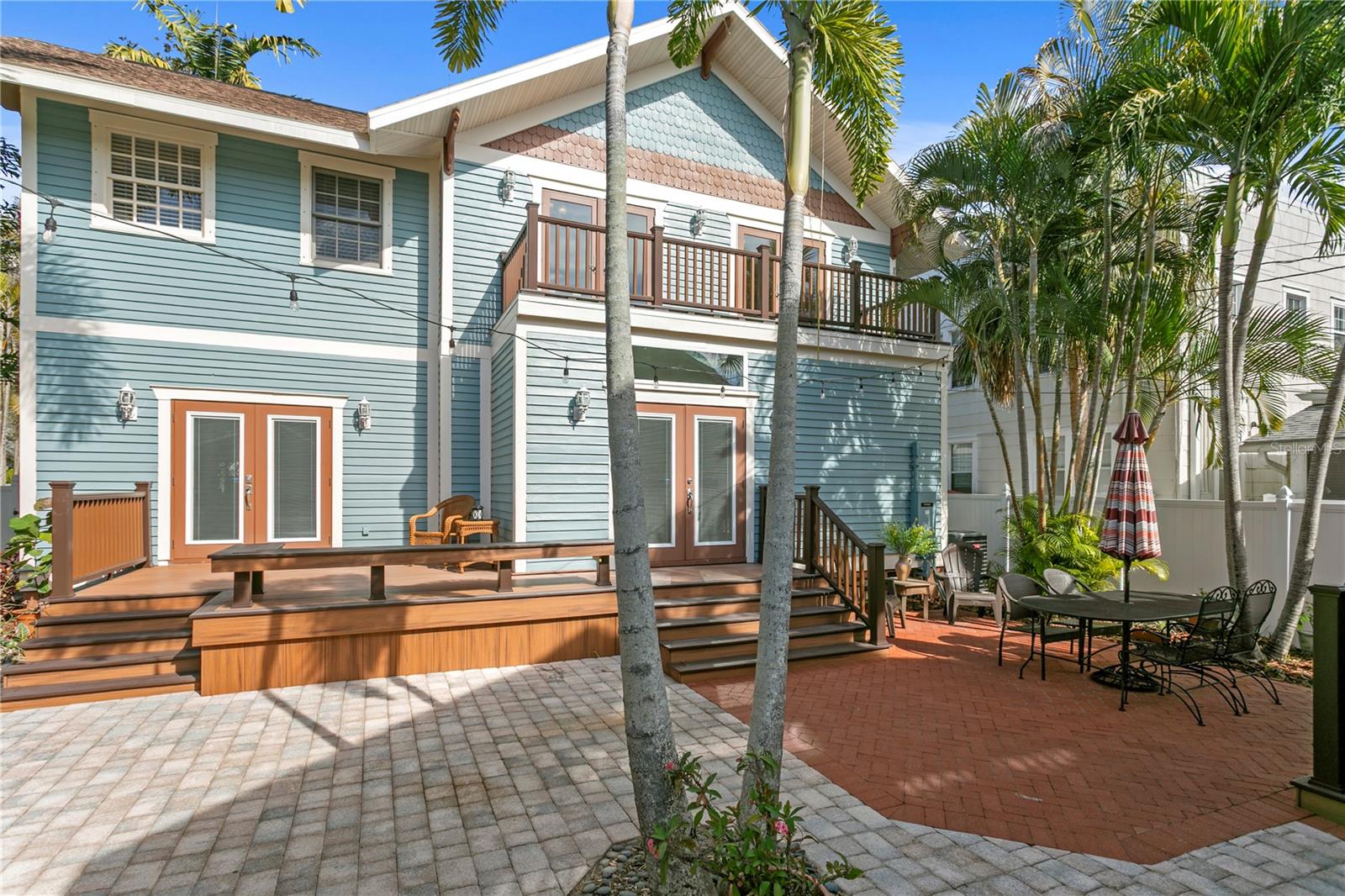 Backyard connection from kitchen and sunroom through double French hurricane impact doors