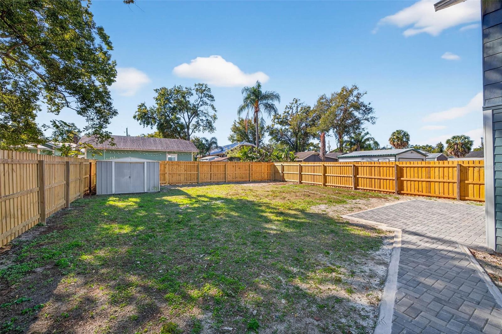 Large Fully Fenced Backyard with a small storage shed