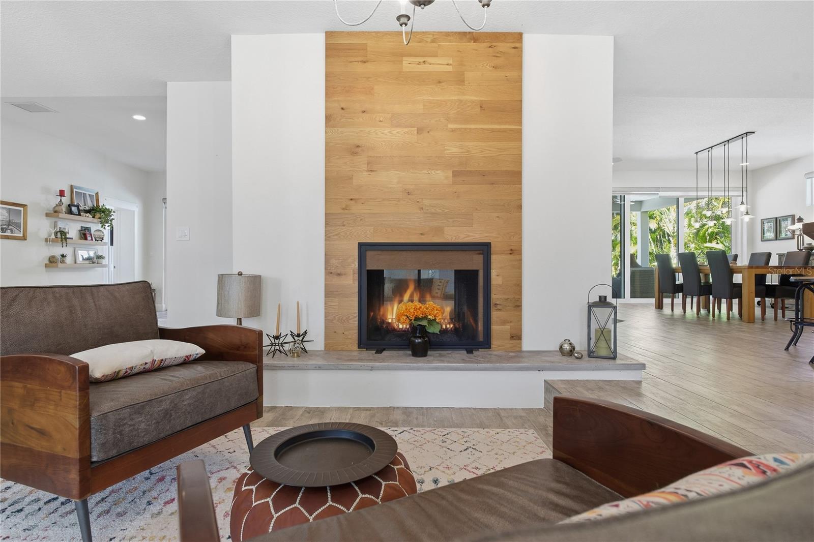 DOUBLE SIDED, WOOD BURNING FIREPLACE, LINKING THE LIVING ROOM AND FAMILY ROOM