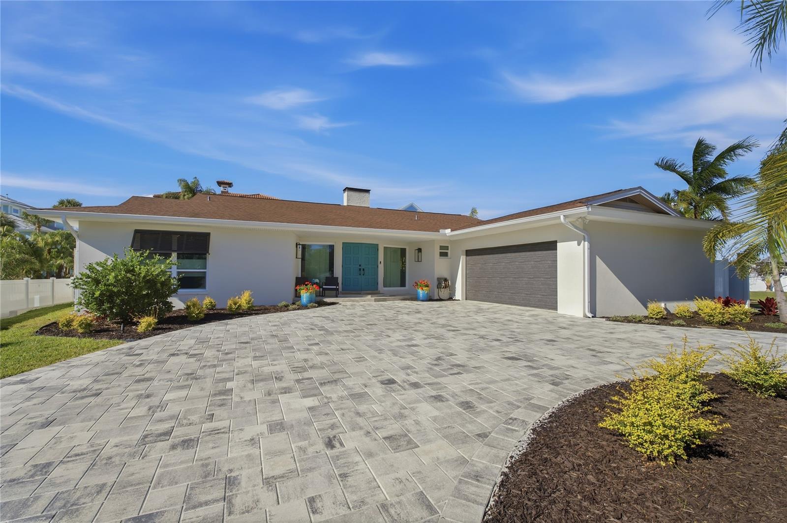 CIRCULAR BRICK-PAVED DRIVEWAY WITH PROFESSIONAL LANDSCAPE PACKAGE BY EARTHSCAPES
