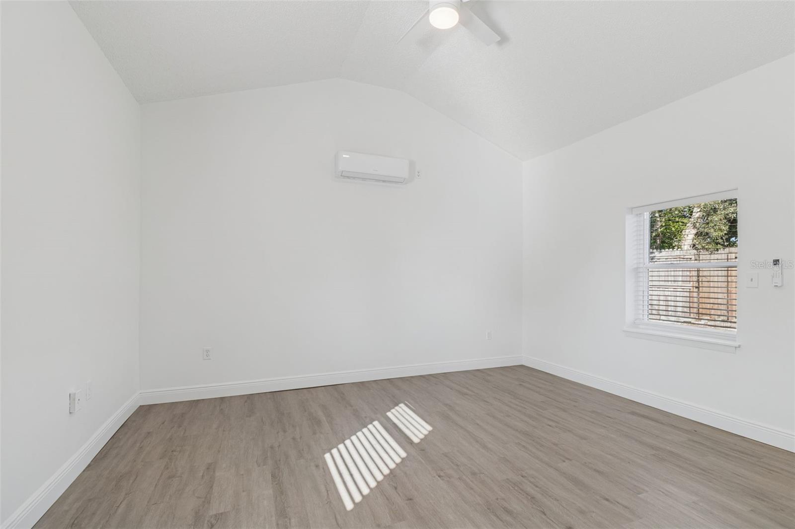 Vaulted ceiling in primary bedroom with separate Mini split ac system.