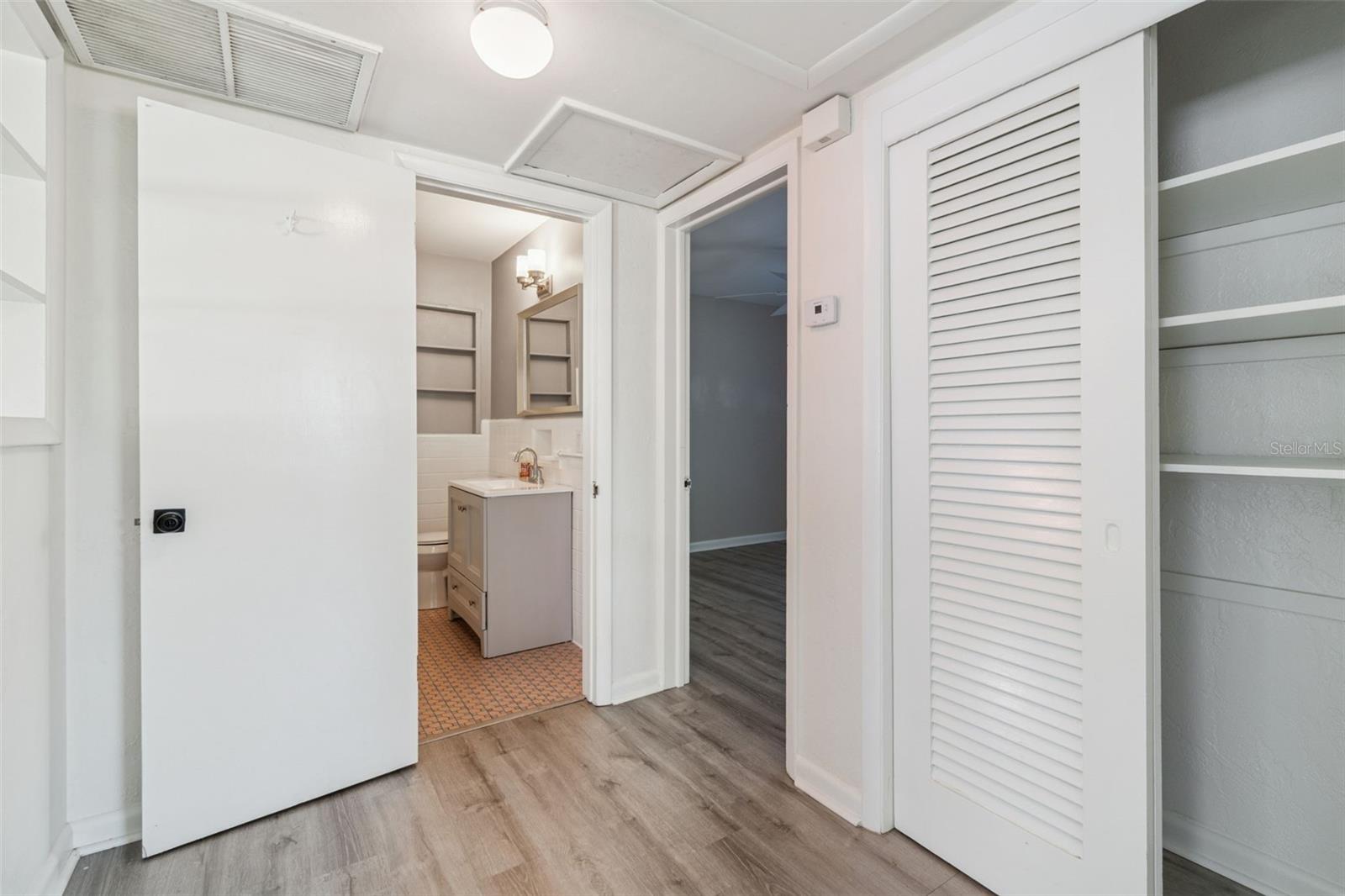 Foyer area to guest bath and secondary bedrooms