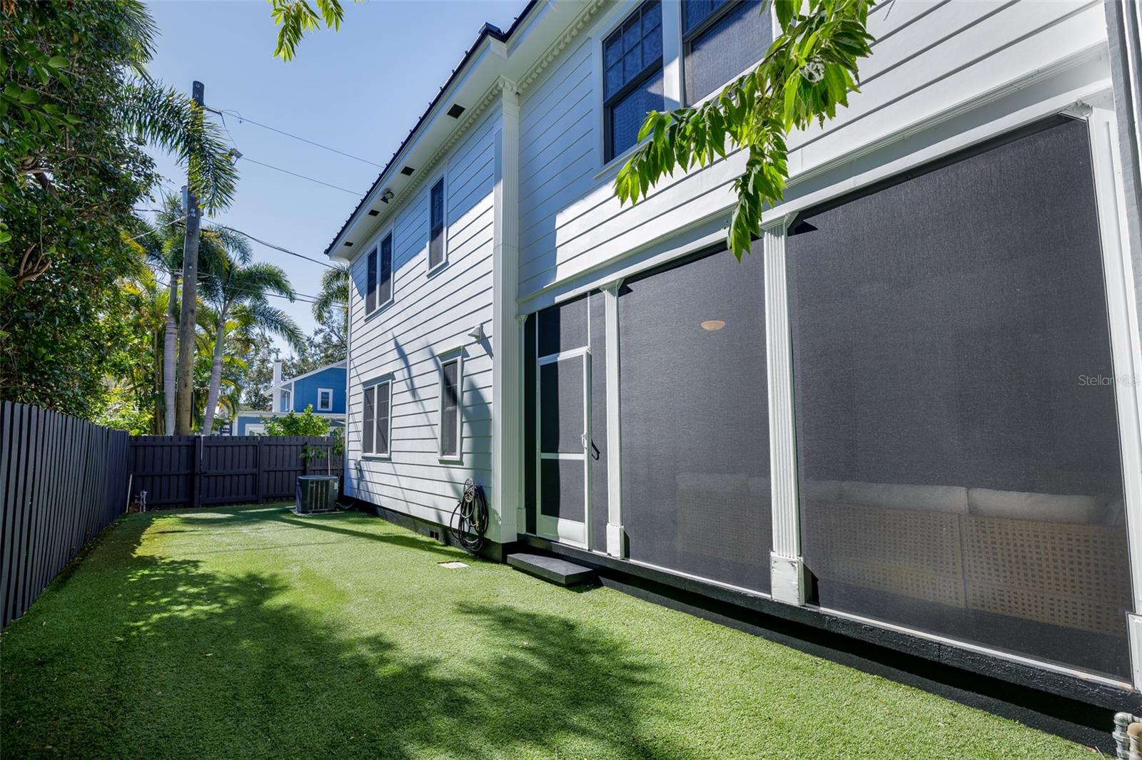East Side of Property, turf with screened-in lanai
