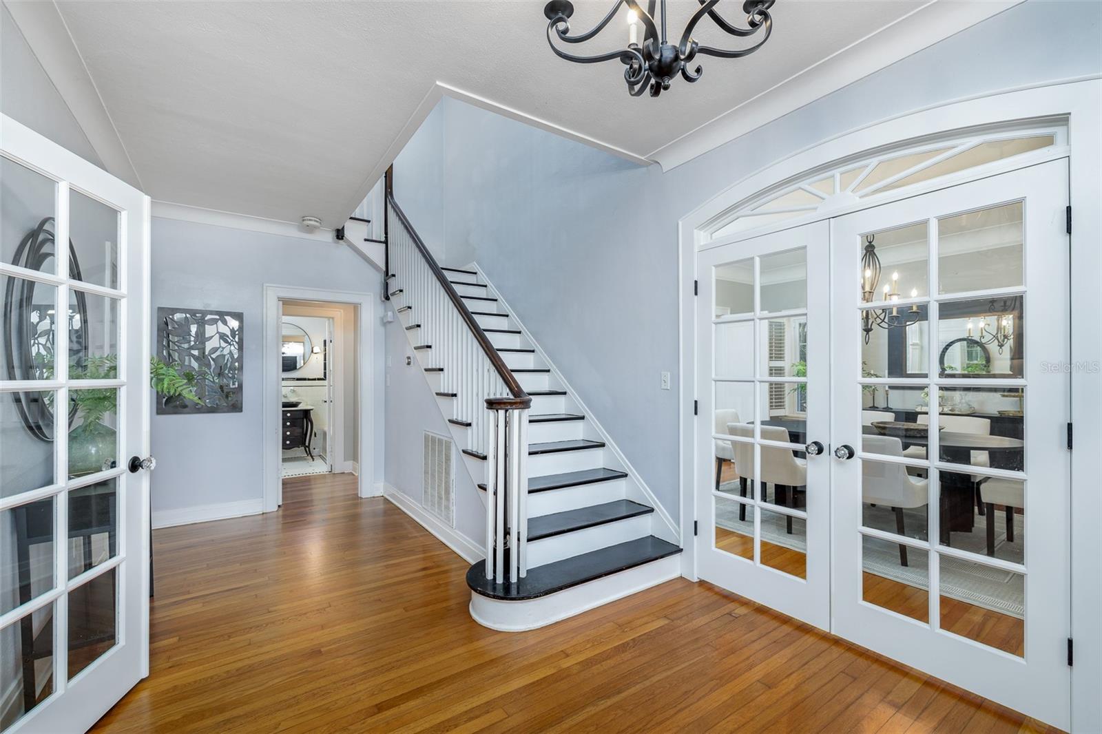 Entry way of home with doors to formal dining (show in picture) and formal living room (not shown on left side)