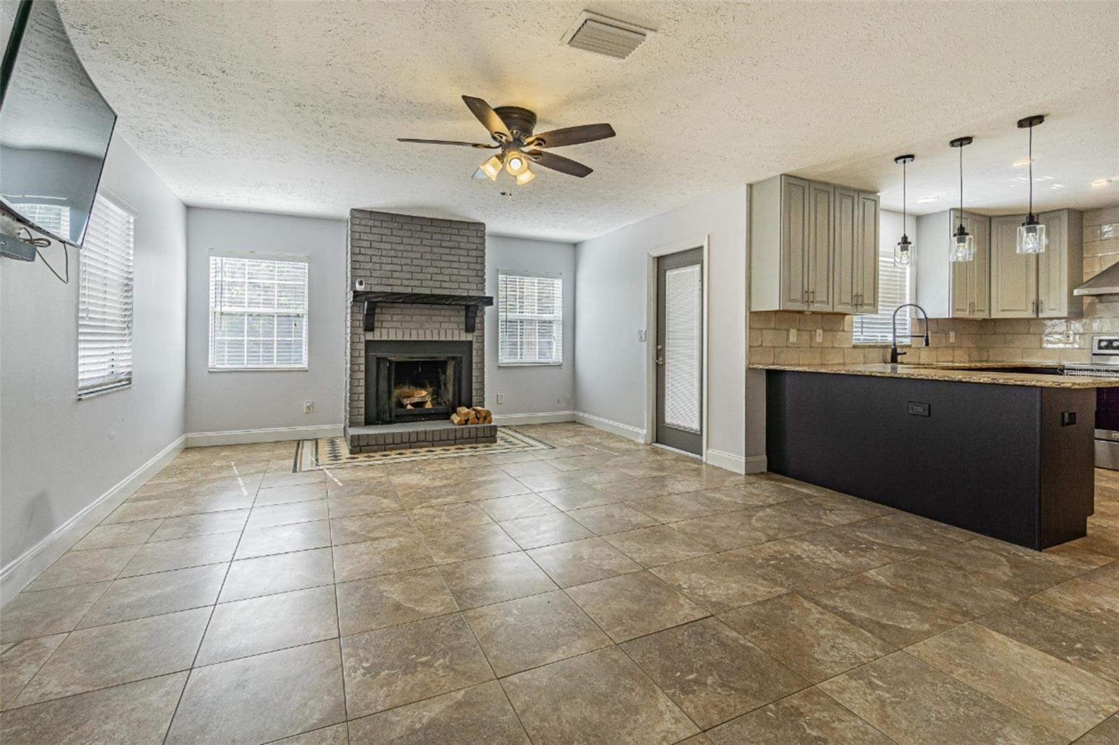 Family room with fireplace, just off the kitchen