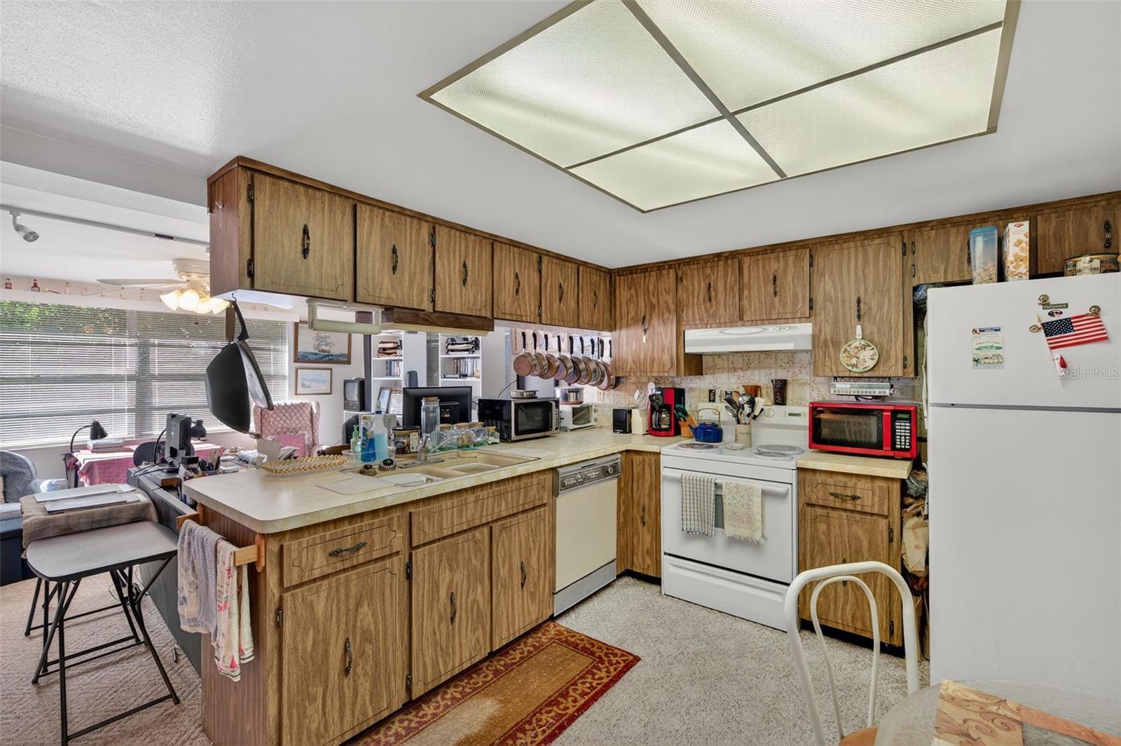 The kitchen features a breakfast bar to the family room