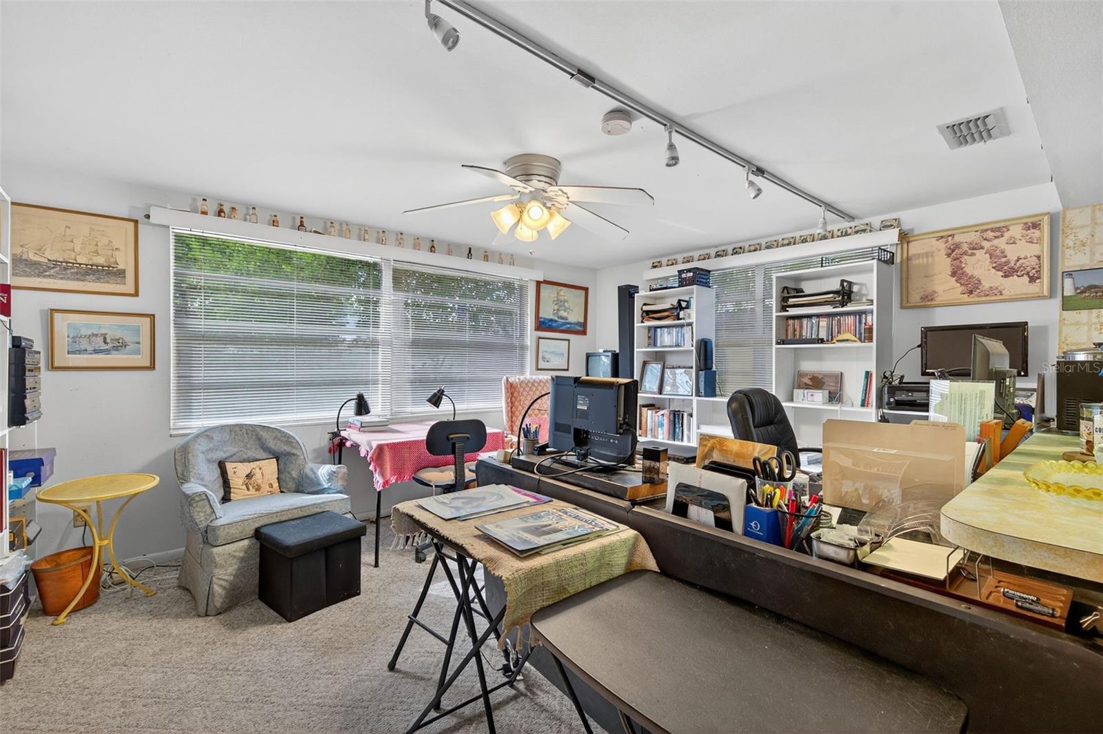 The spacious and bright family room features sliders to the florida room. Currently used as office space