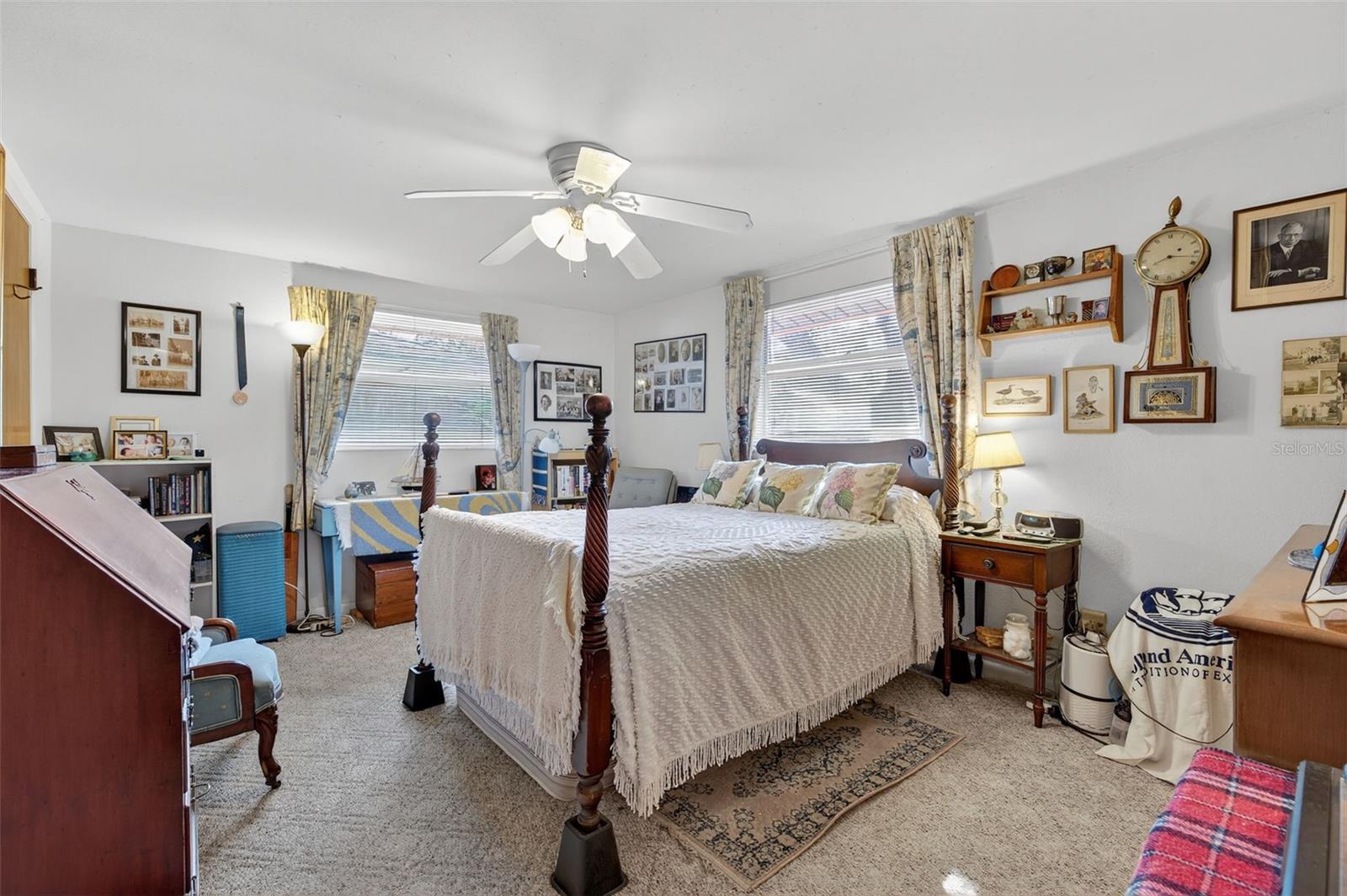 Primary bedroom featuring 2 windows and walk-in closet. ~15'x11'