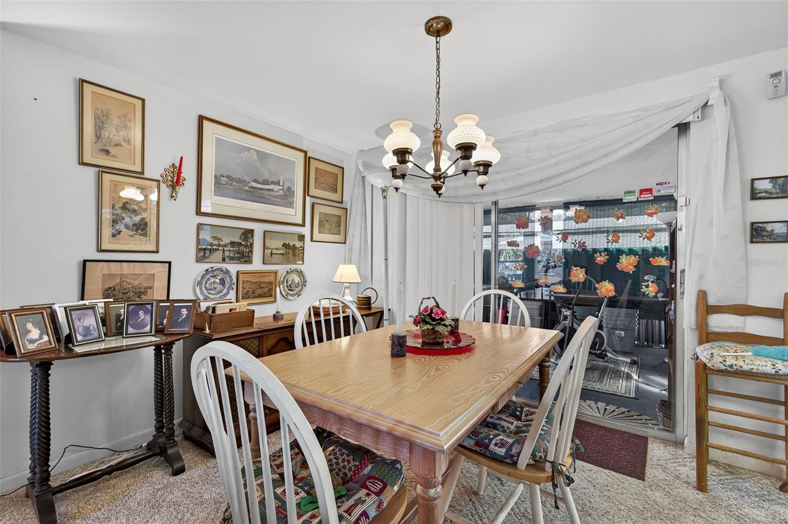 The dining room is open to the living room and features sliders to the Florida room