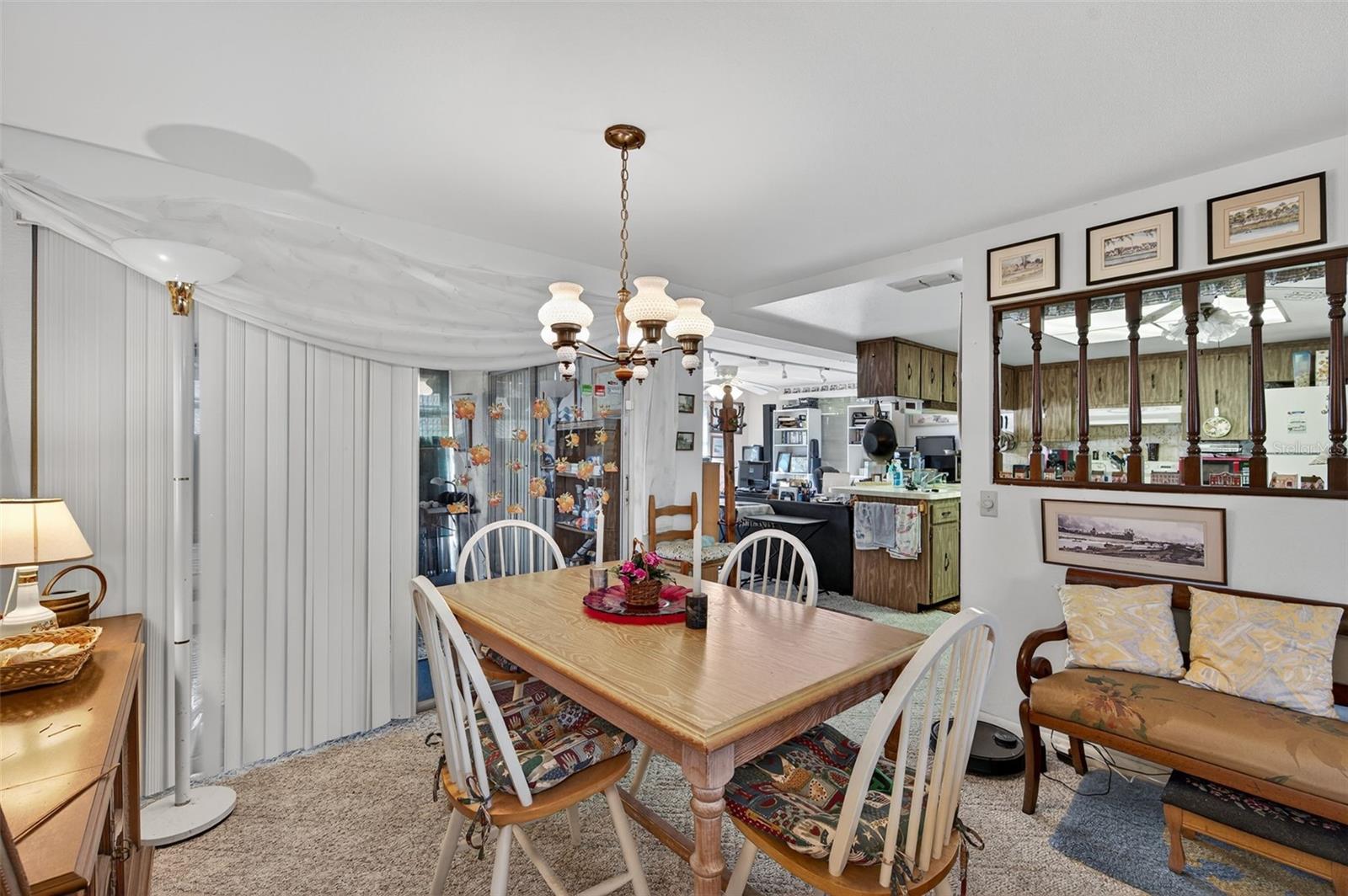 The dining room flows toward the eat in kitchen
