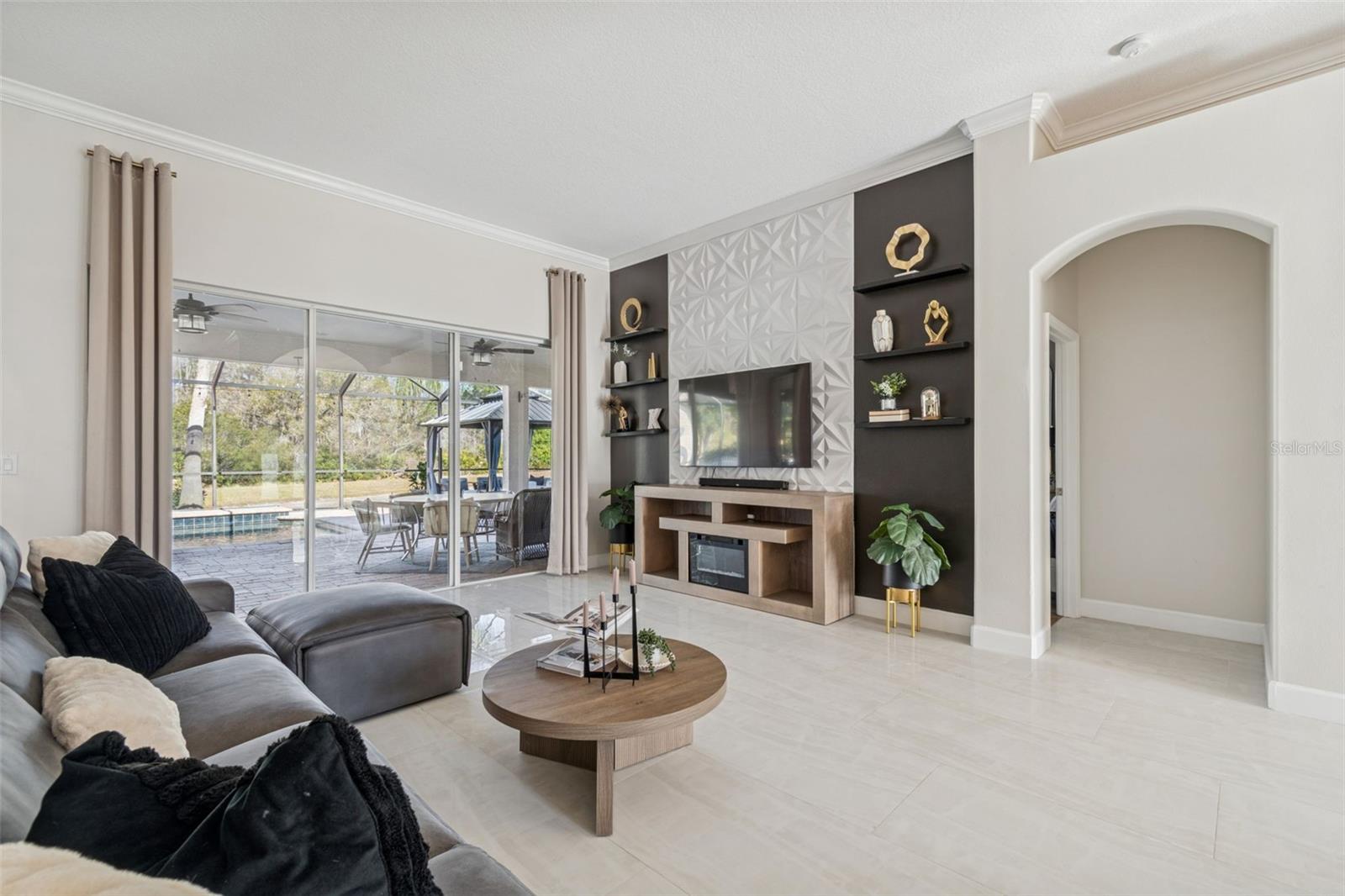 Sliders out to back patio. Custom decorative wall with shelving.