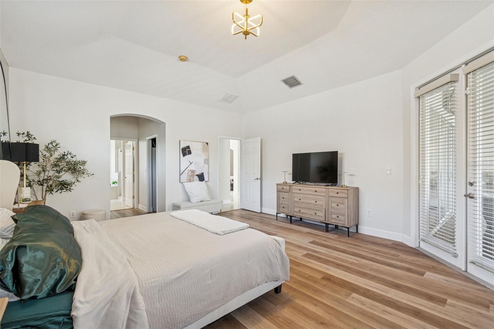 Doors from primary suite extend to covered lanai.