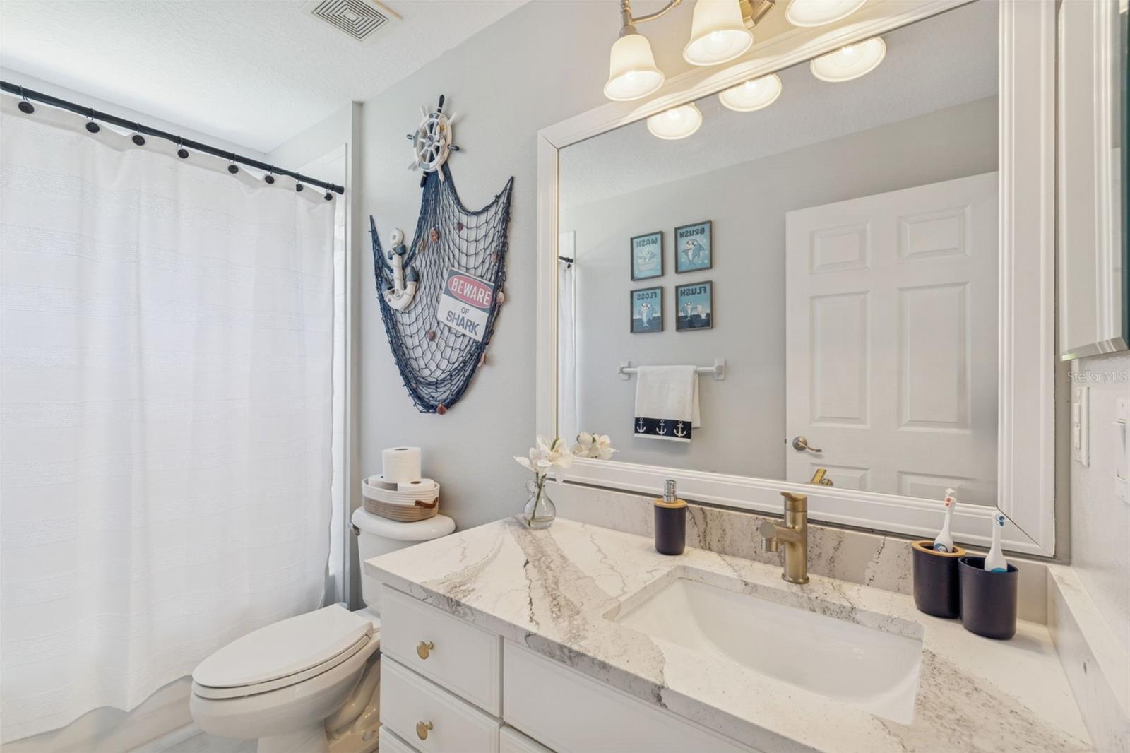 Full bathroom shared by two guest bedrooms. New countertops and new fixtures here.